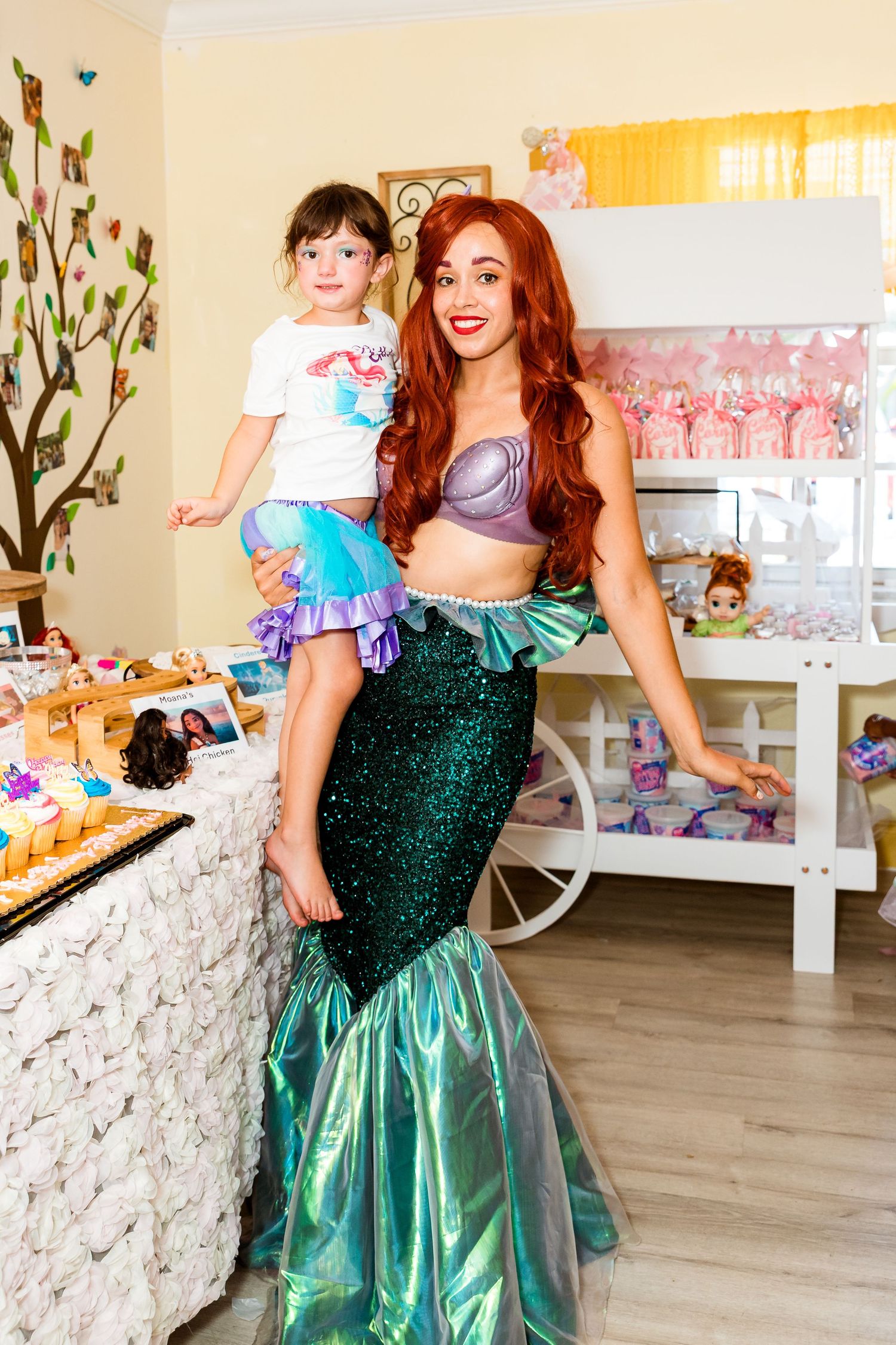 A festively decorated children's party room with a dessert cart and enchanted mermaid theme decor.