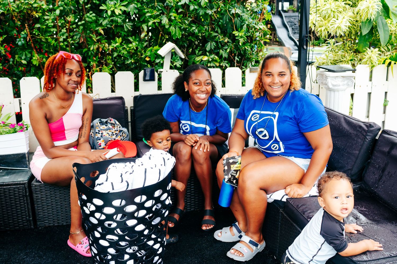 Group relaxing on outdoor patio furniture during a summer gathering.