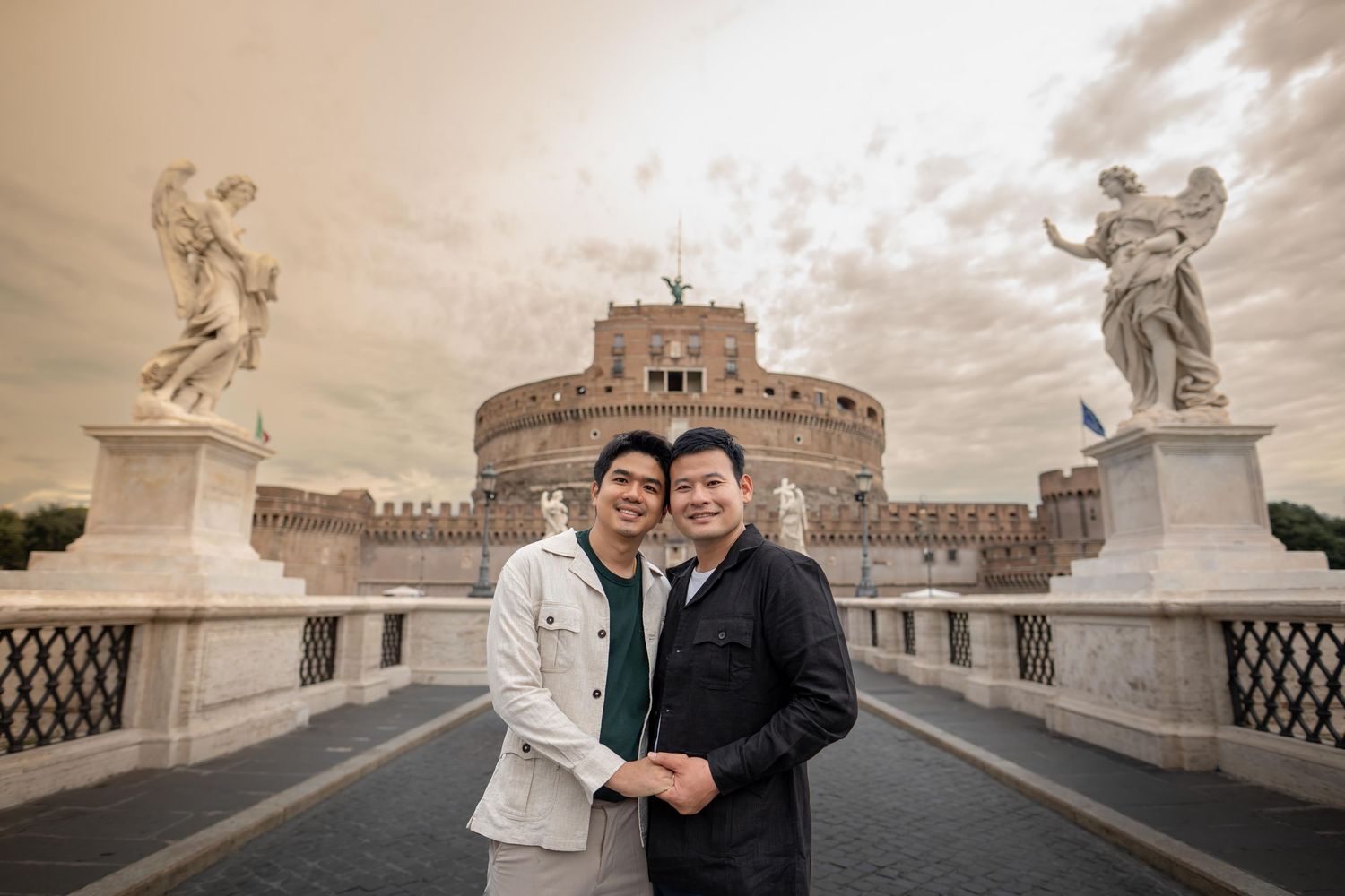 Couple embracing on Castel Sant'Angelo bridge in Rome, Italy.