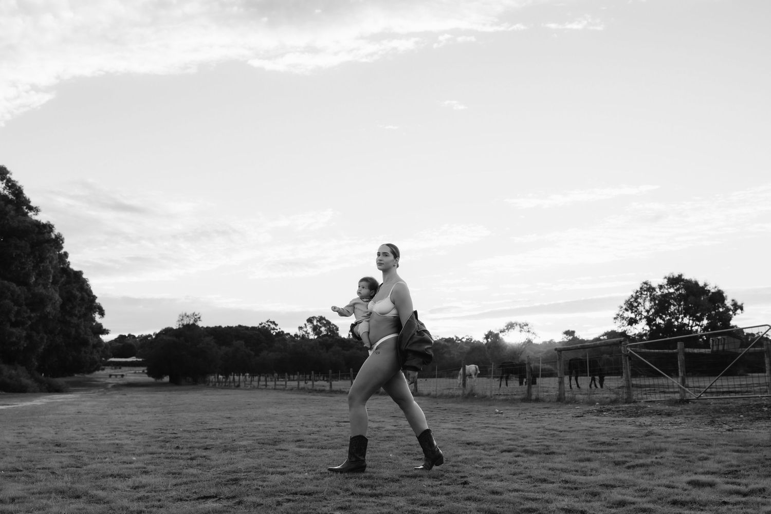 A panoramic series of black and white photos showing two people interacting in an open field.
