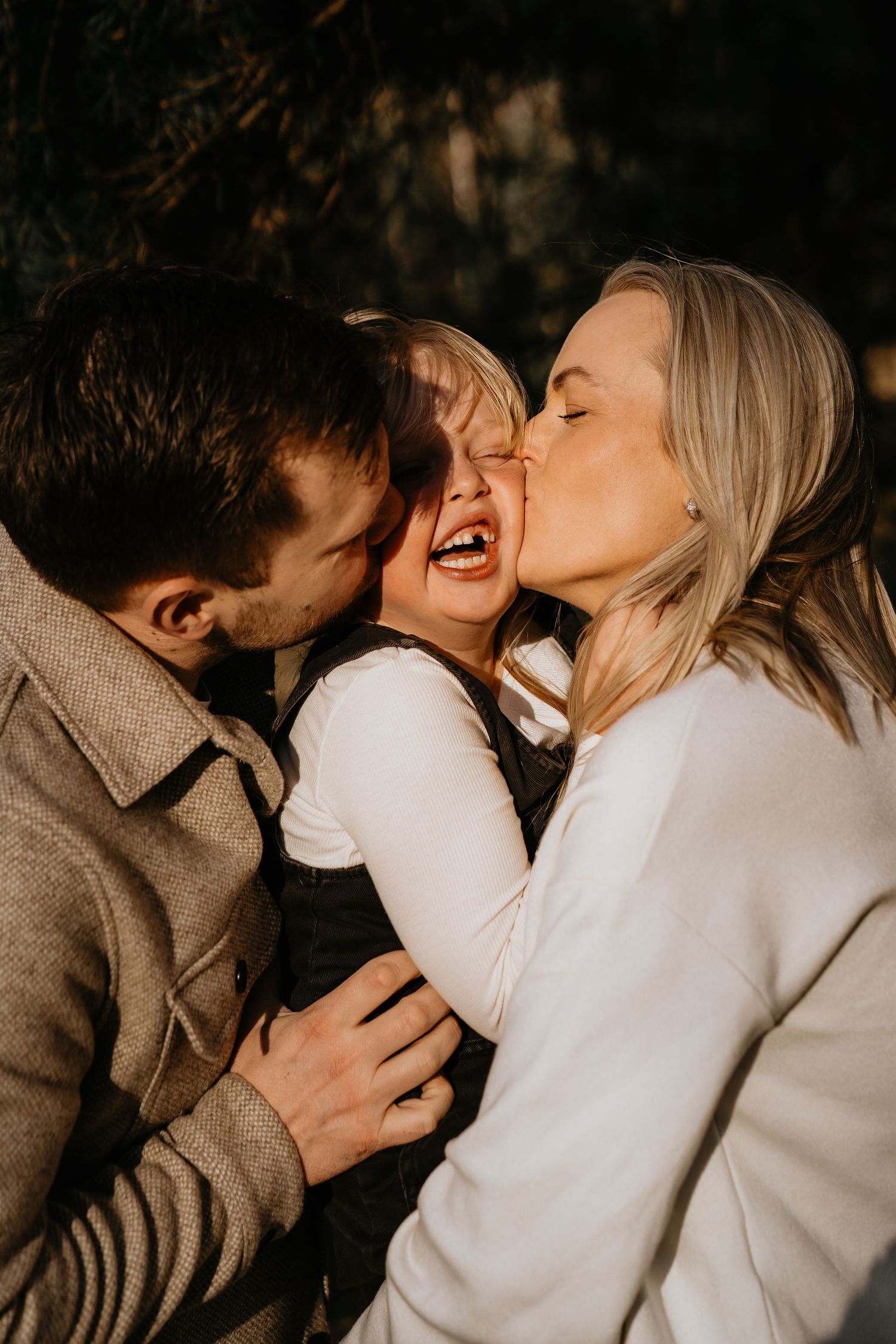 A joyful family moment captured outdoors showing love and connection between parents and child.
