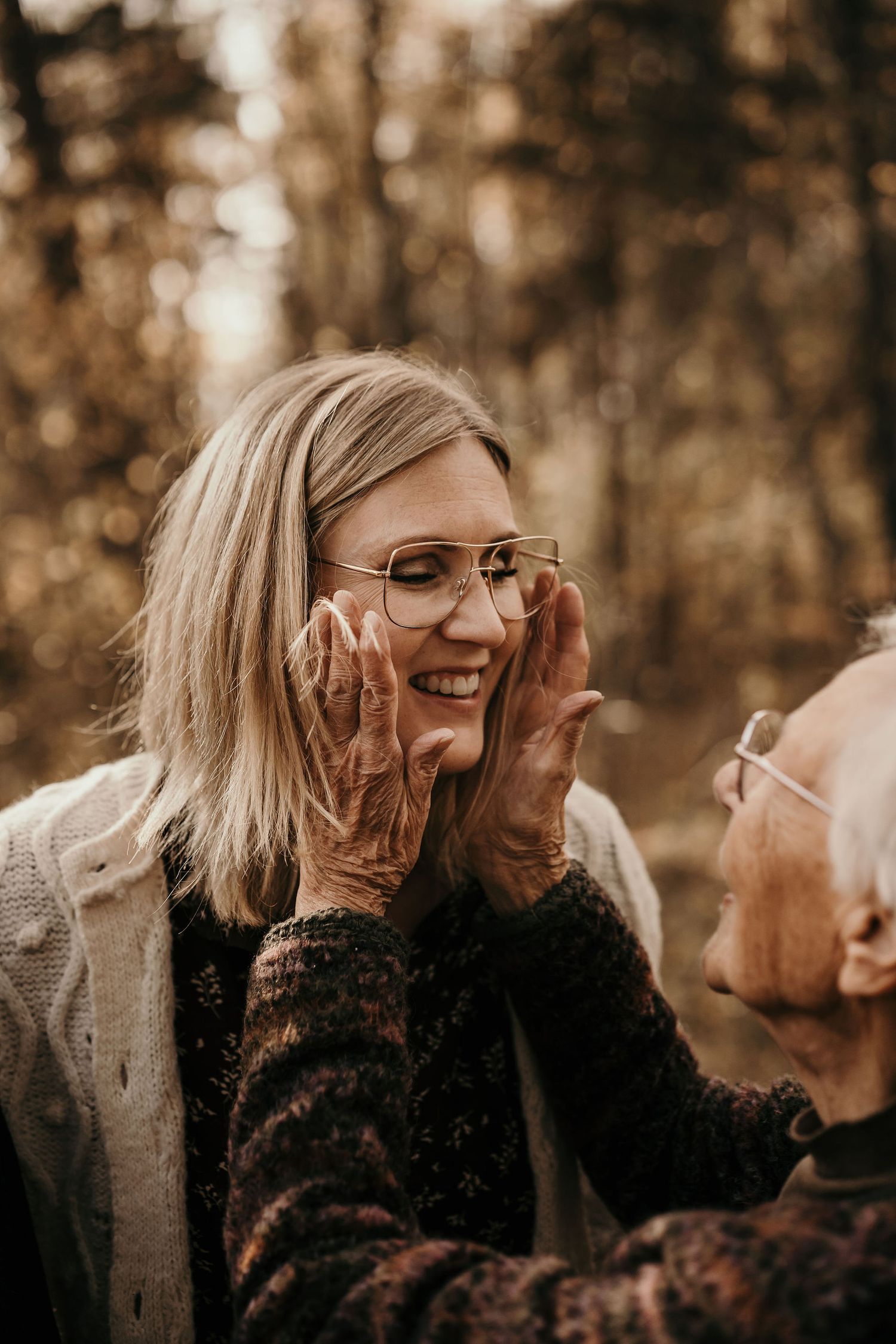A joyful moment captured in sepia tones as two people share laughter and connection outdoors.