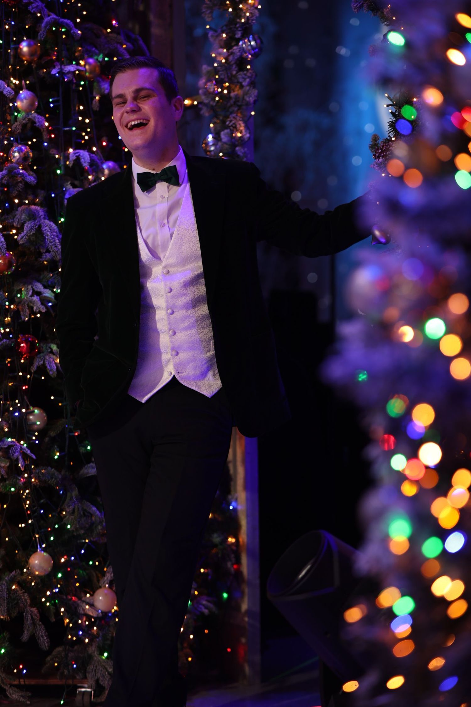 Elegant wedding reception scene with colorful bokeh lights and Christmas decorations creating magical ambiance.