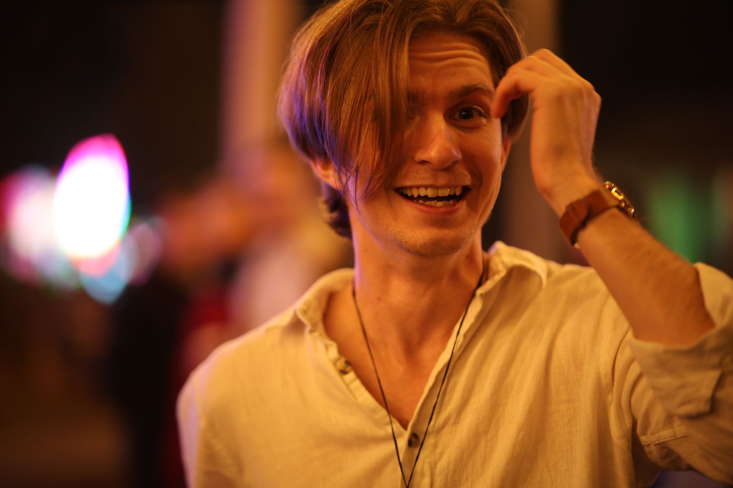 A sequence of six similar photos showing someone in a white shirt smiling in a dimly lit setting.