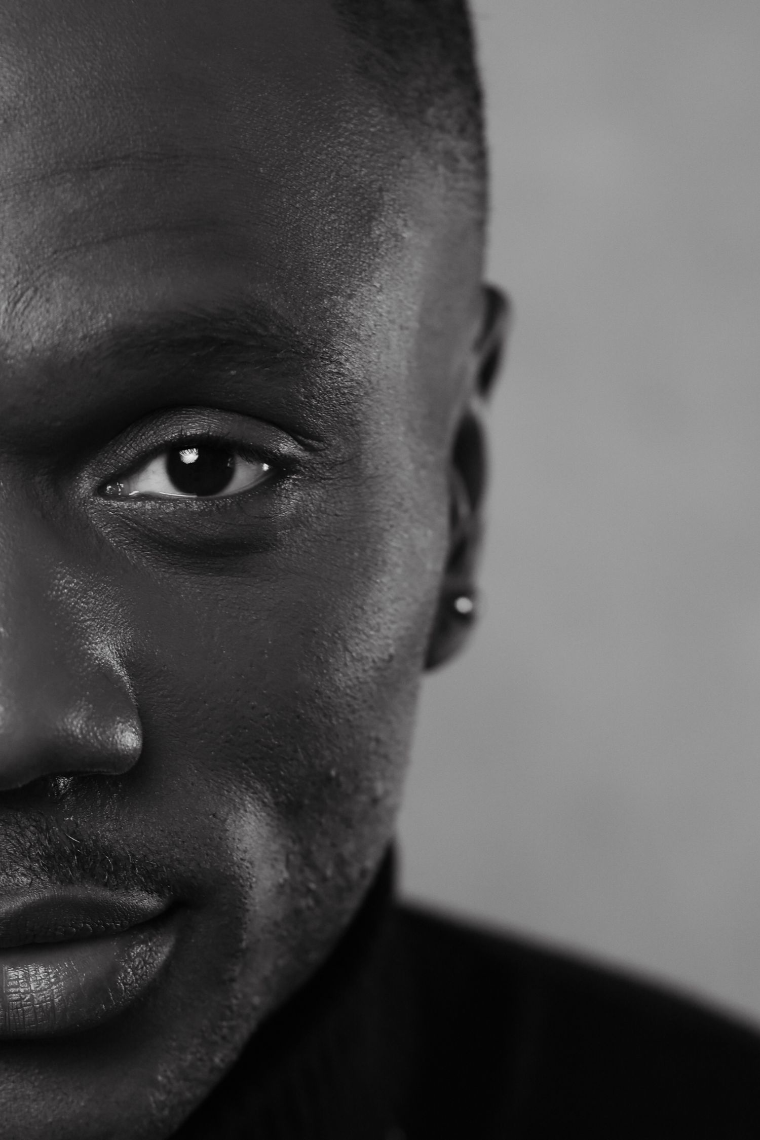 Black and white artistic portrait series showing close-up facial features in dramatic lighting.