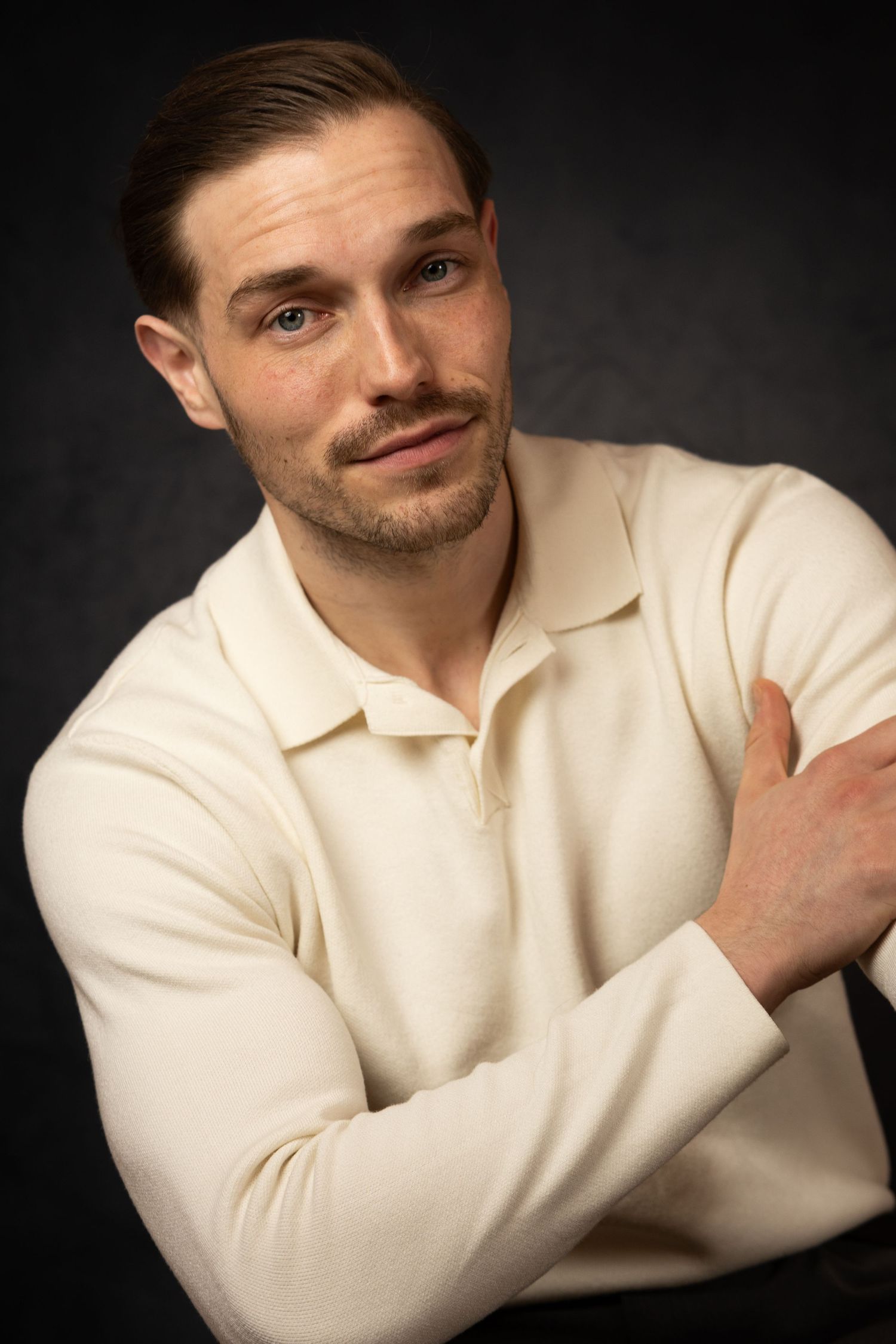Professional portrait series showing a person in a cream sweater against a dark background with various expressive poses.