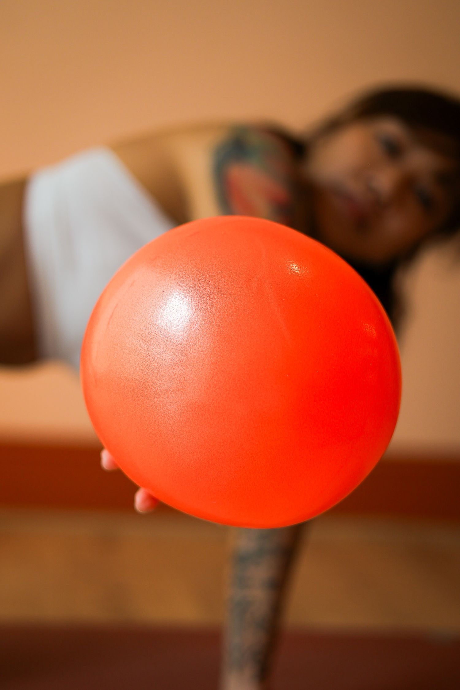A sequence of photos showing a red balloon gradually deflating against a blurred brown background.