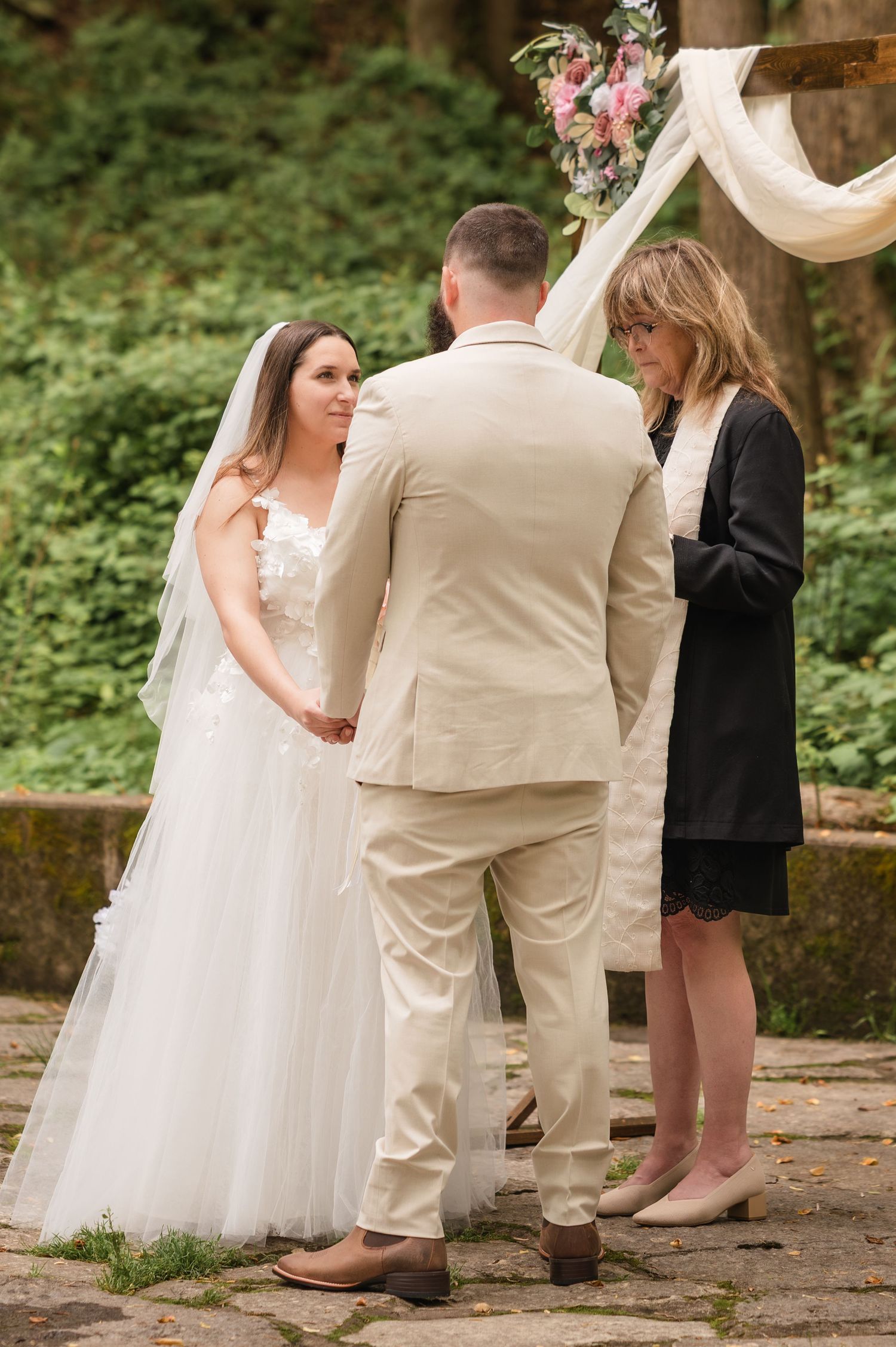 A series of wedding ceremony photos showing guests and attendees standing on a stone path in an outdoor garden setting.