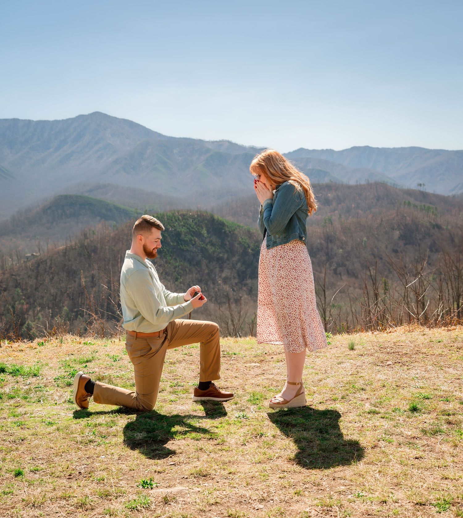 A sequence of photos capturing a marriage proposal on a mountaintop field with mountain ranges in the background.