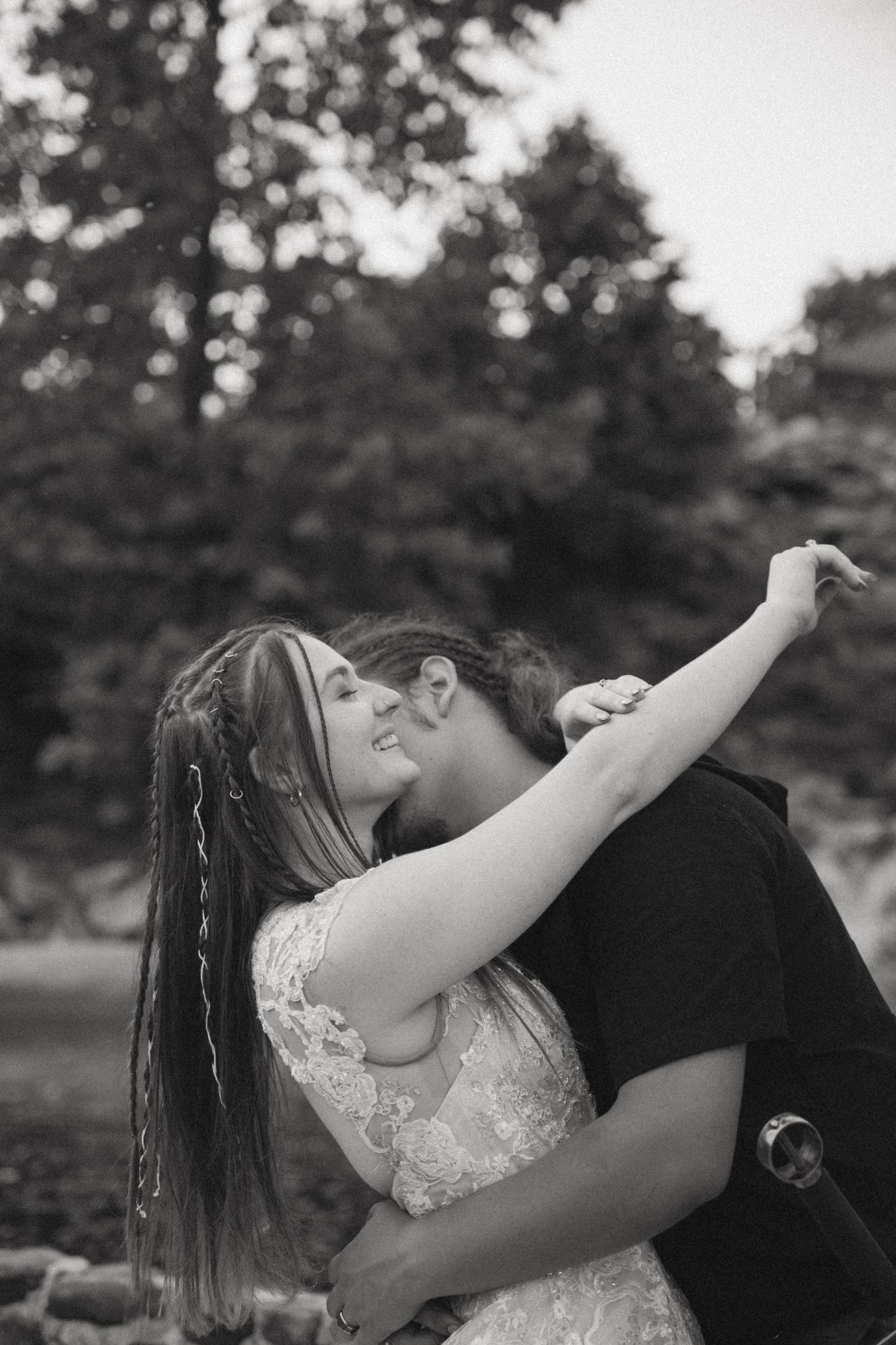 Black and white romantic photography sequence shows wedding couple dancing and embracing in an outdoor garden setting.