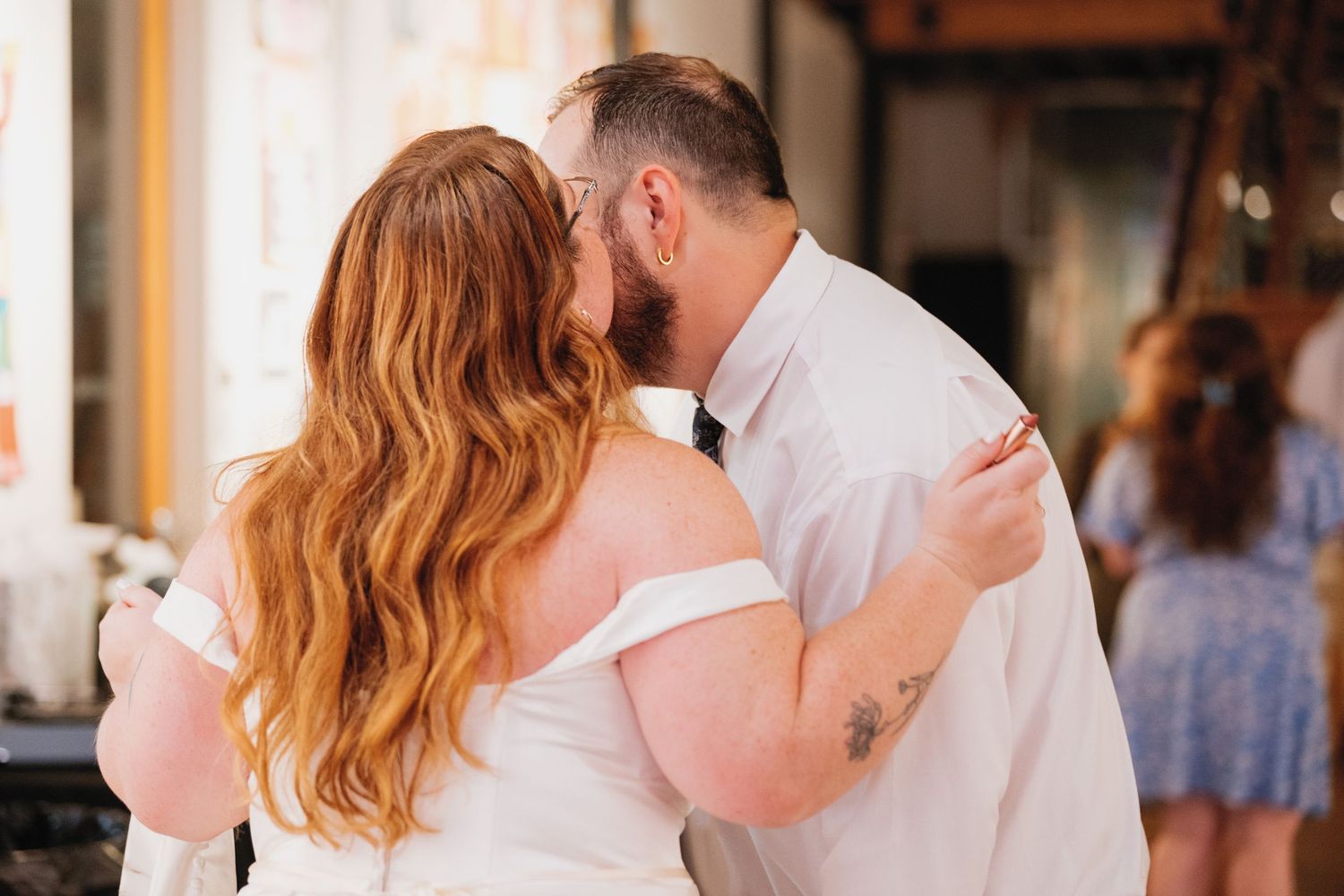 A couple dancing together in an intimate ballroom style pose, showcasing graceful movement in a wedding setting.