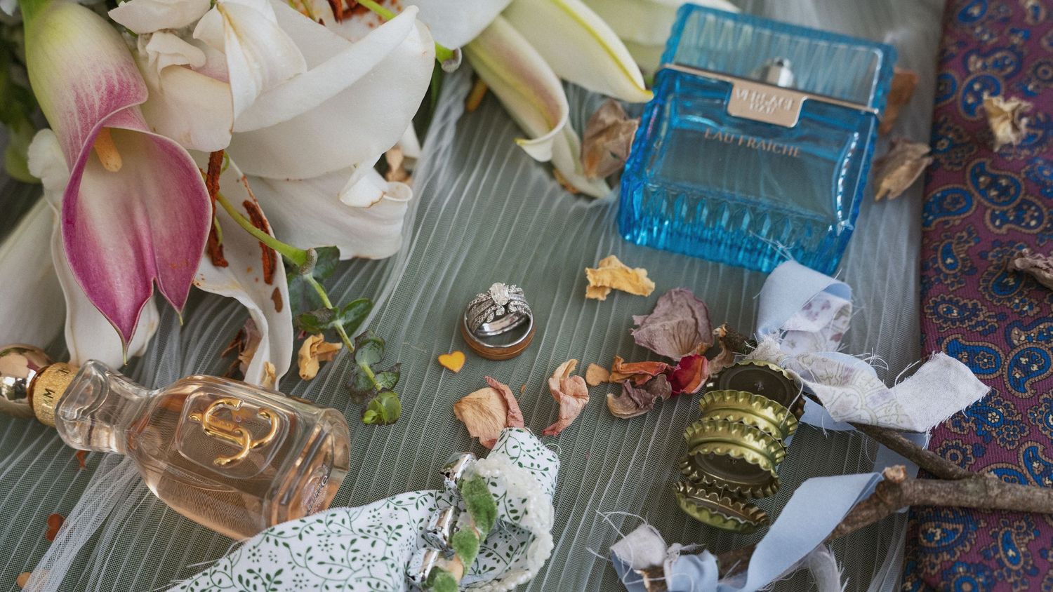 Vintage-style table setting with antique glassware, candles and decorative elements against a blue backdrop.