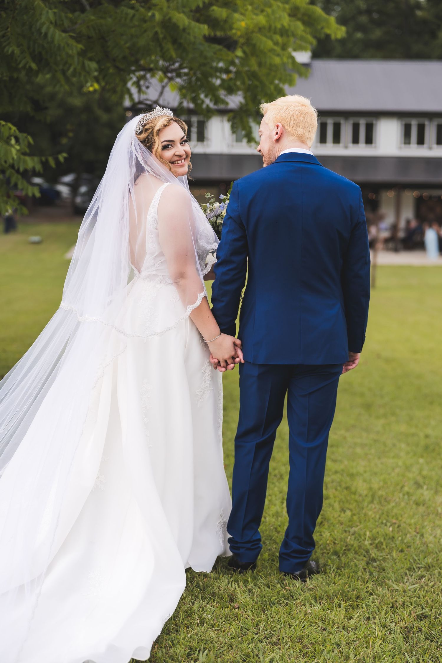 A series of romantic wedding photos showing a couple walking across a green lawn with the bride's veil flowing in the breeze.