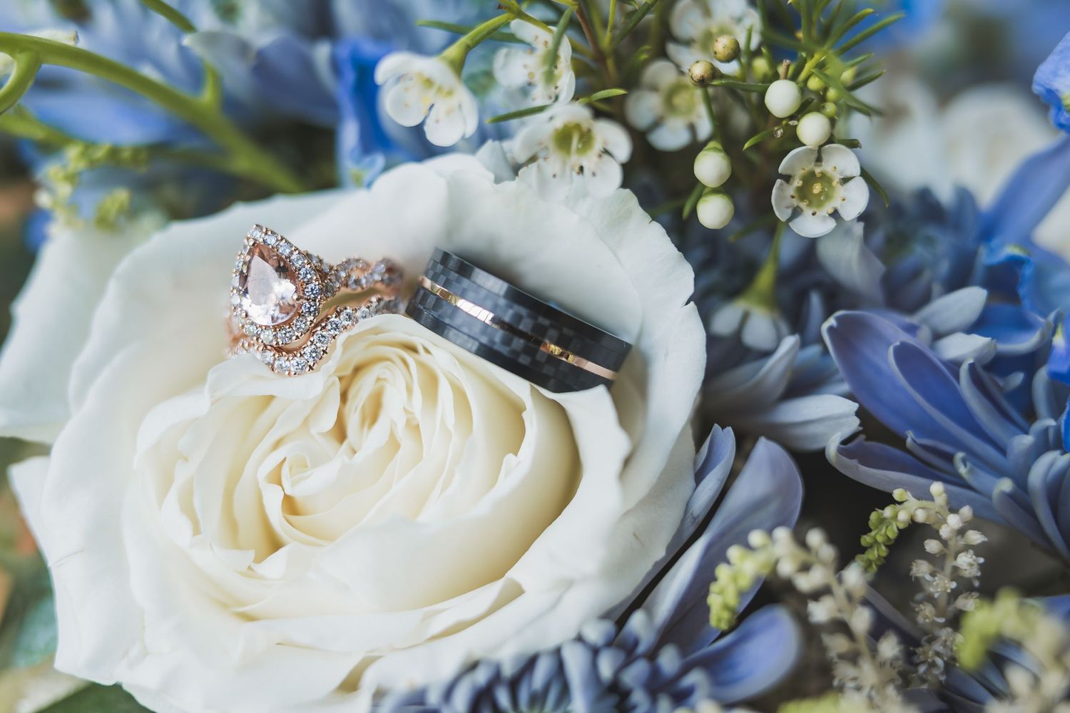 An elegant bridal bouquet features ivory roses and blue hydrangeas accented with delicate baby's breath.