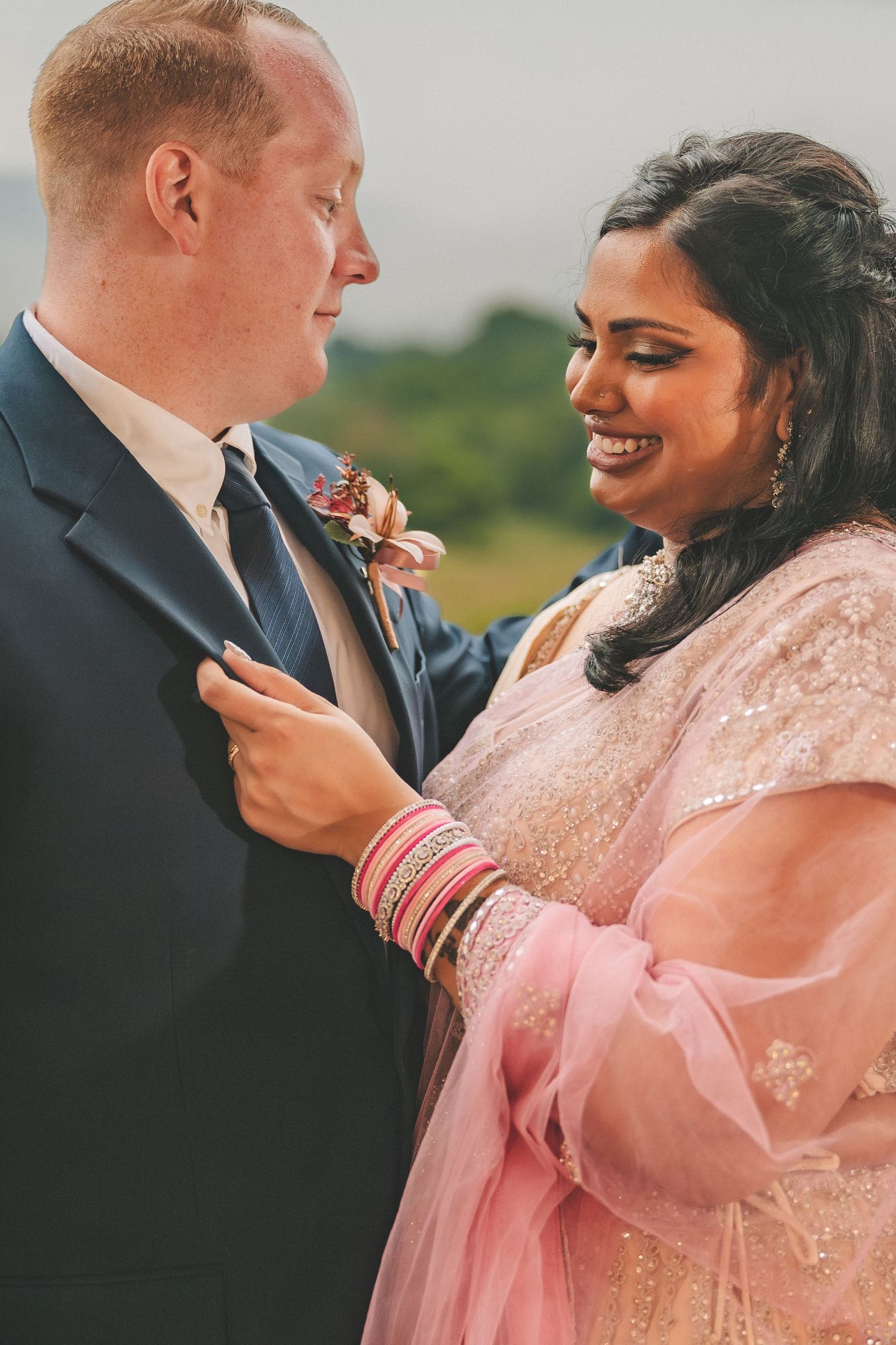 A series of intimate candid moments between a couple in formal attire, with her wearing a pink lace dress and him in a navy suit.