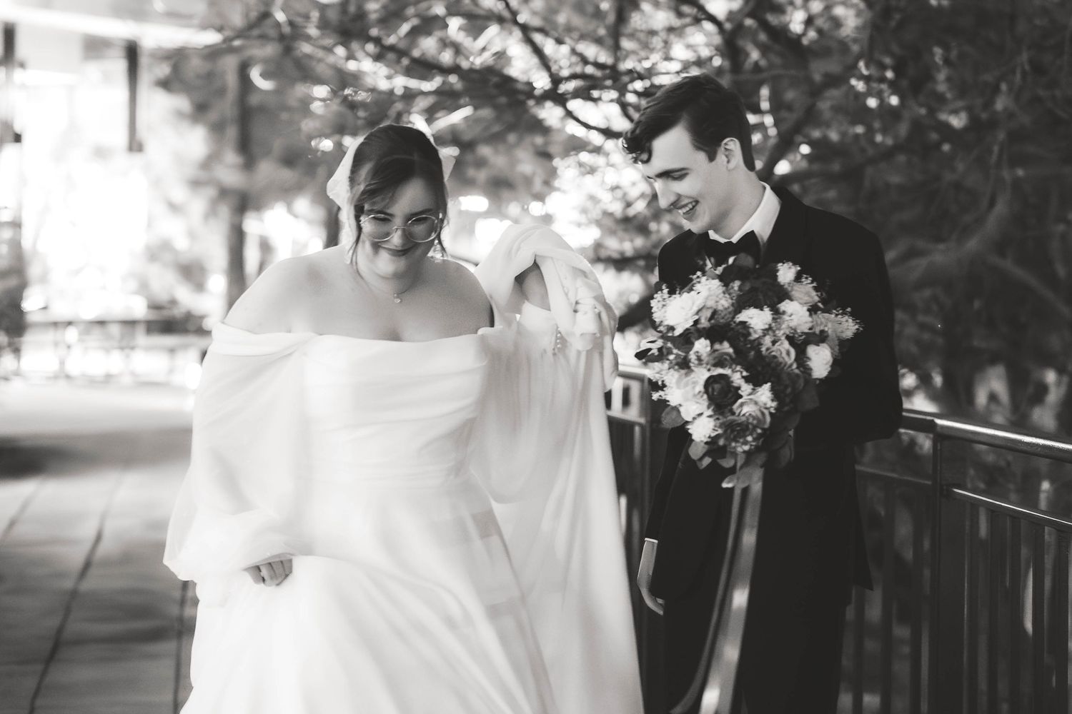 A couple shares a romantic moment in black and white photography on their wedding day.