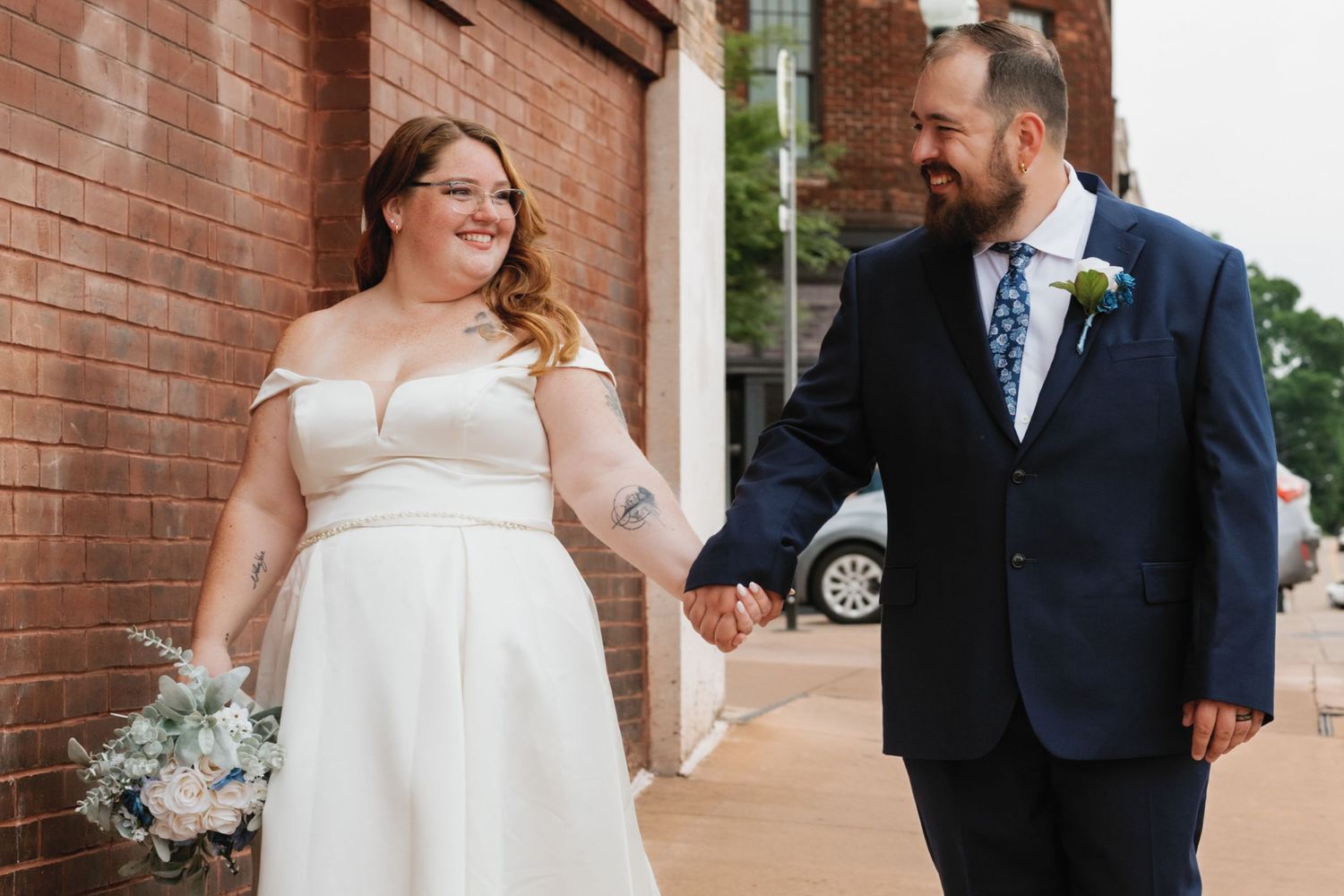 A series of wedding photos showing a couple at various angles against a brick wall as they interact during their special day.