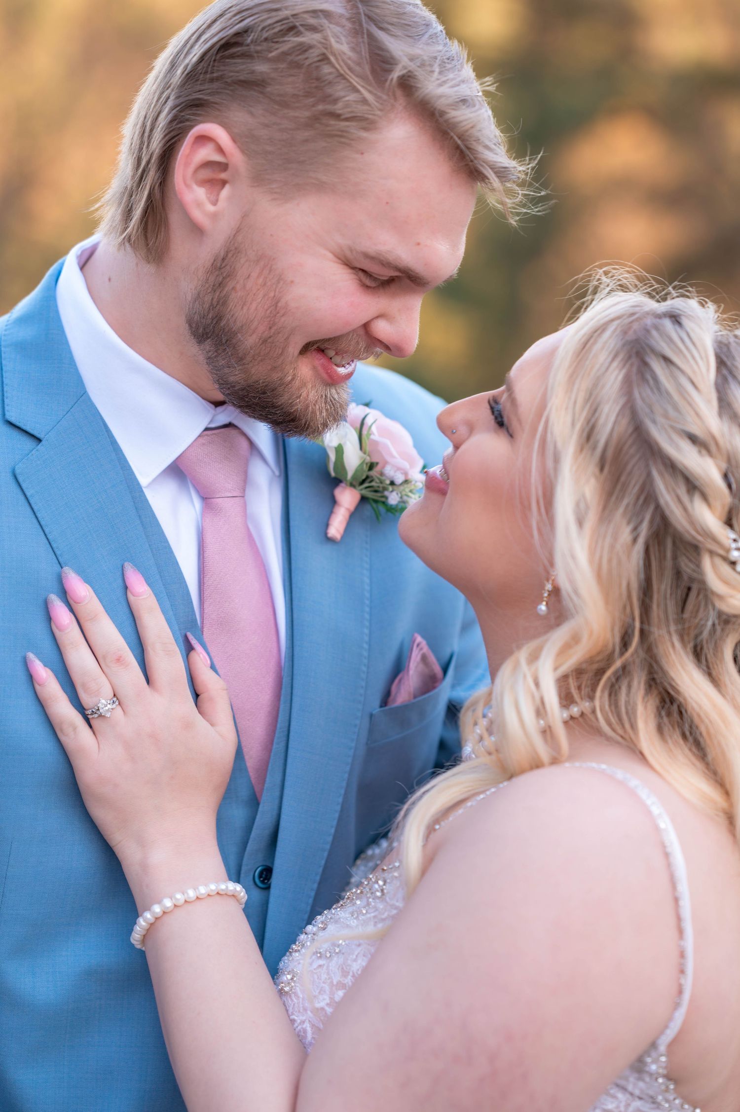 Four connected romantic wedding photos showing a couple in a light blue suit and white dress during an intimate outdoor moment.