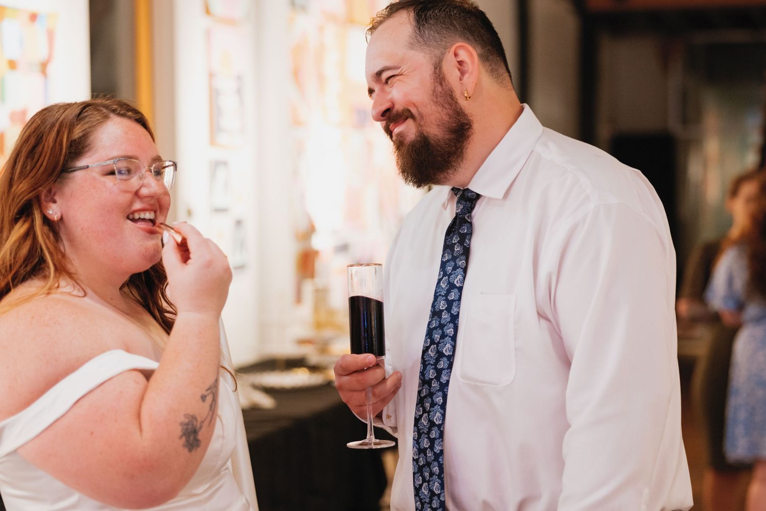 A sequence of tender moments at a wedding reception shows a couple toasting and sharing sips from their glasses.