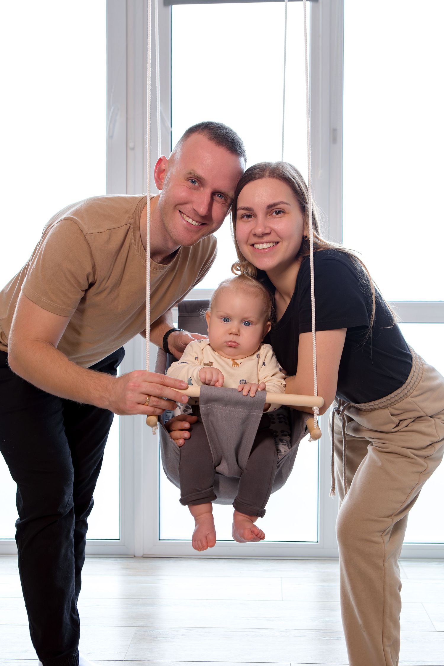 Four sequential photos showing playful interaction between adults and baby in a bright indoor setting.