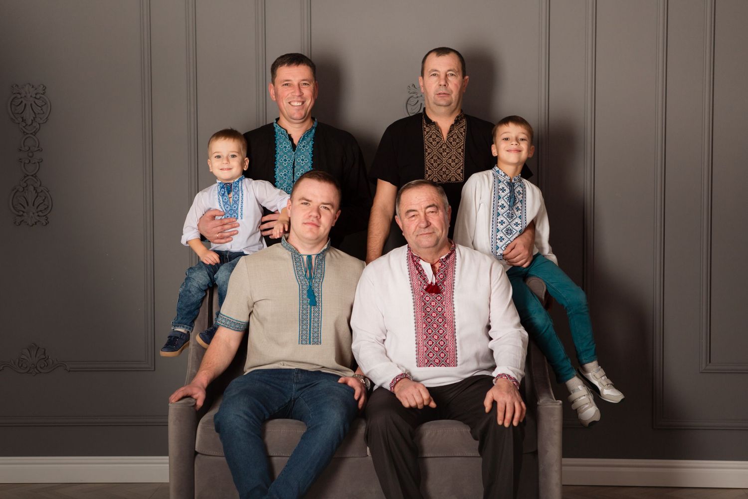 Multi-generational male family members posed together in casual attire.