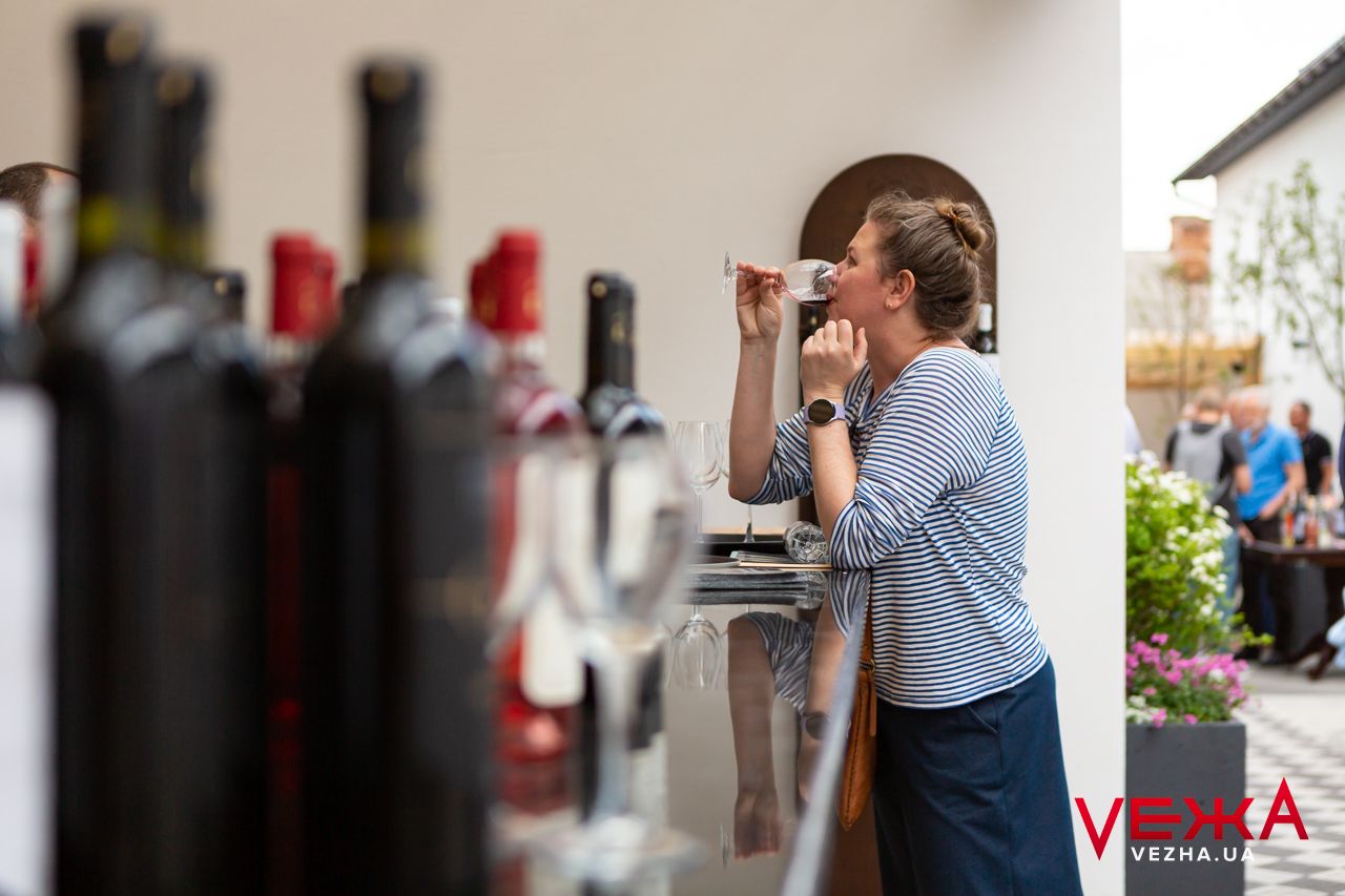 Wine tasting station with bottles displayed against light background.