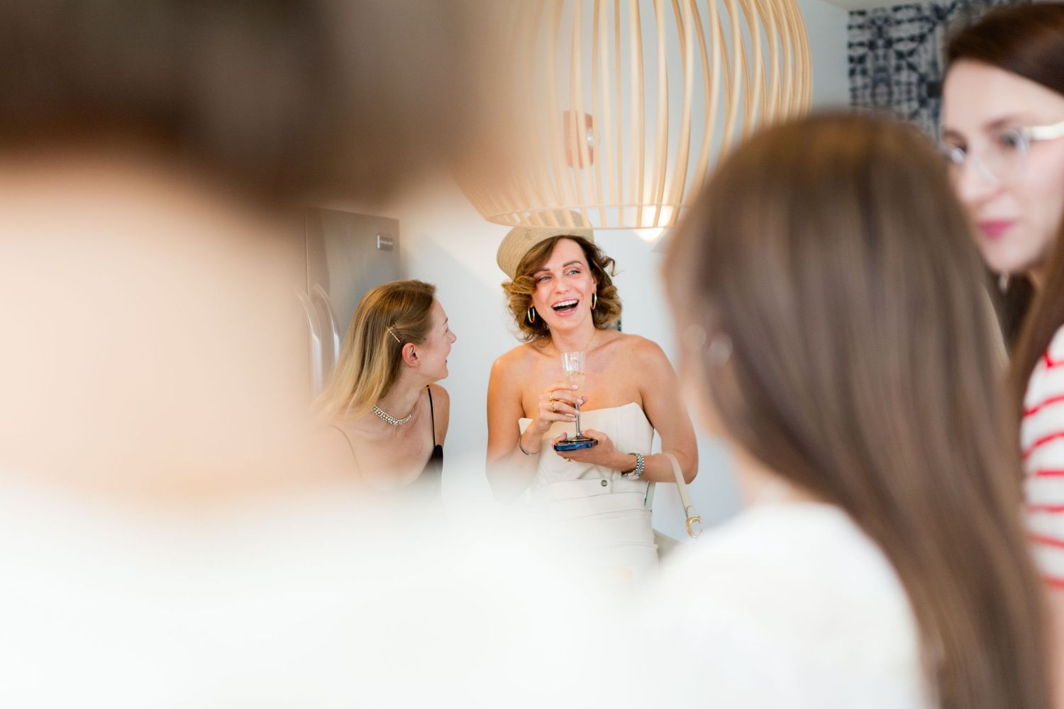 Group gathered in modern room with pendant lighting celebrating together.