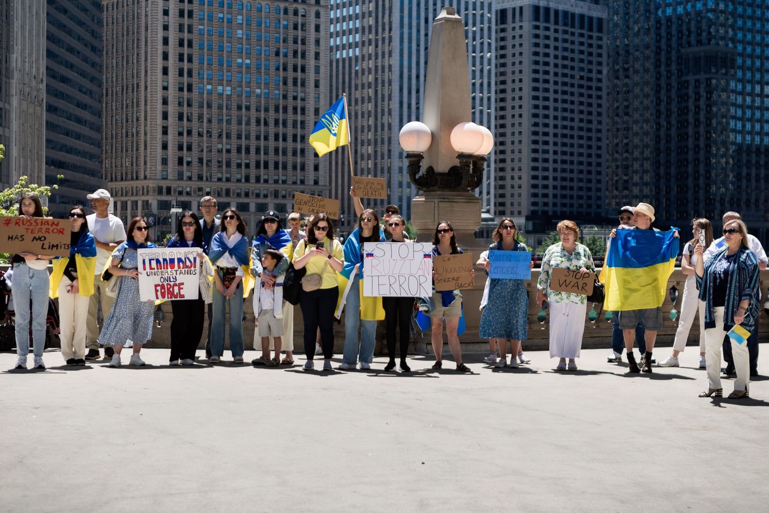 Protesters hold Ukrainian flags and signs during a demonstration in downtown Chicago.