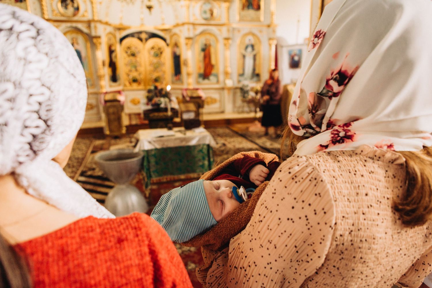 Interior of an ornate orthodox church with traditional decorations and icons.