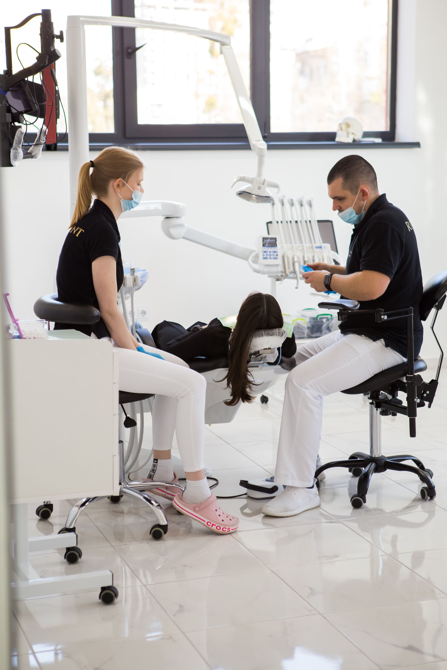 Modern dental office setting with medical professionals performing treatment.