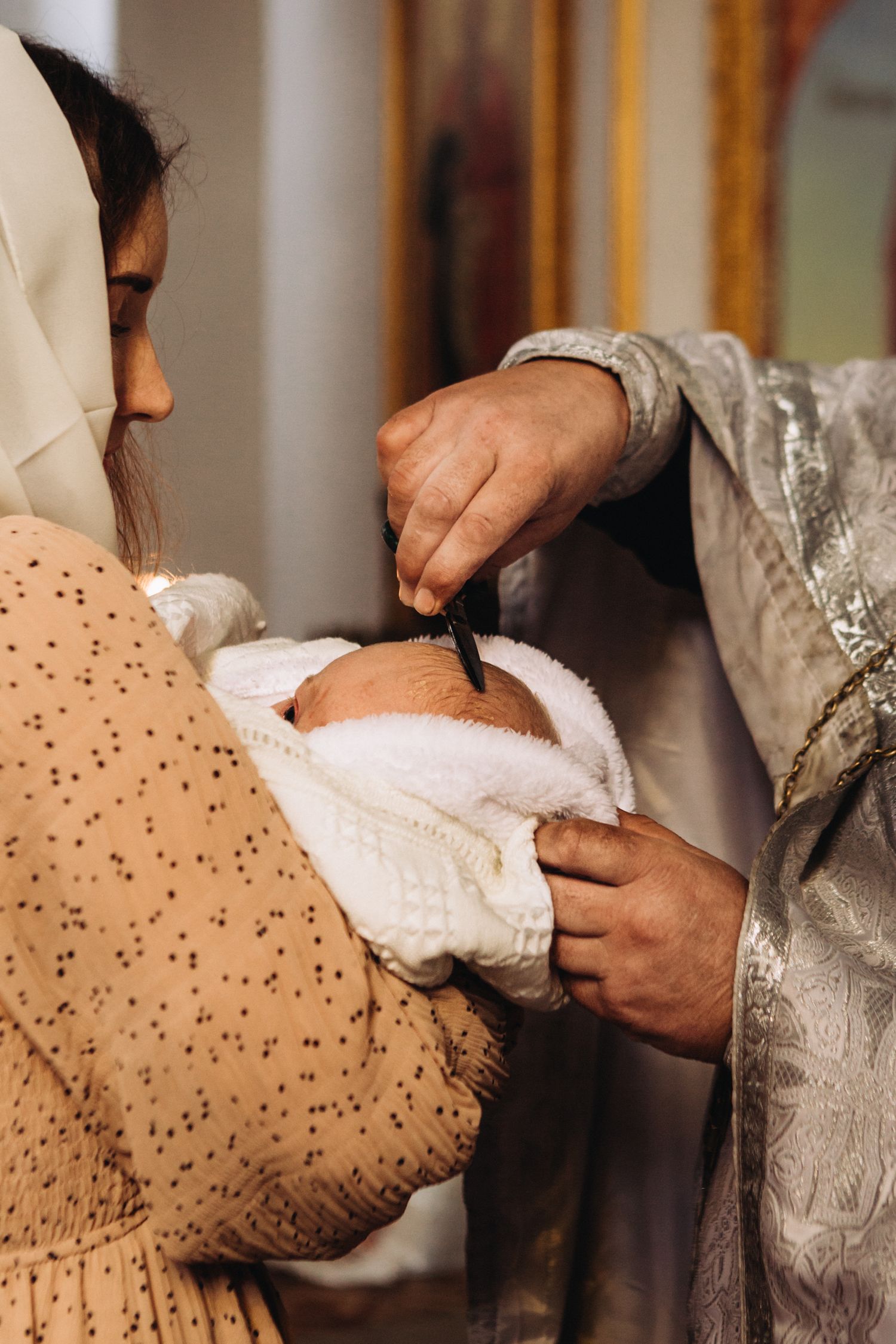 Close-up of hands performing a religious ritual with a white cloth.