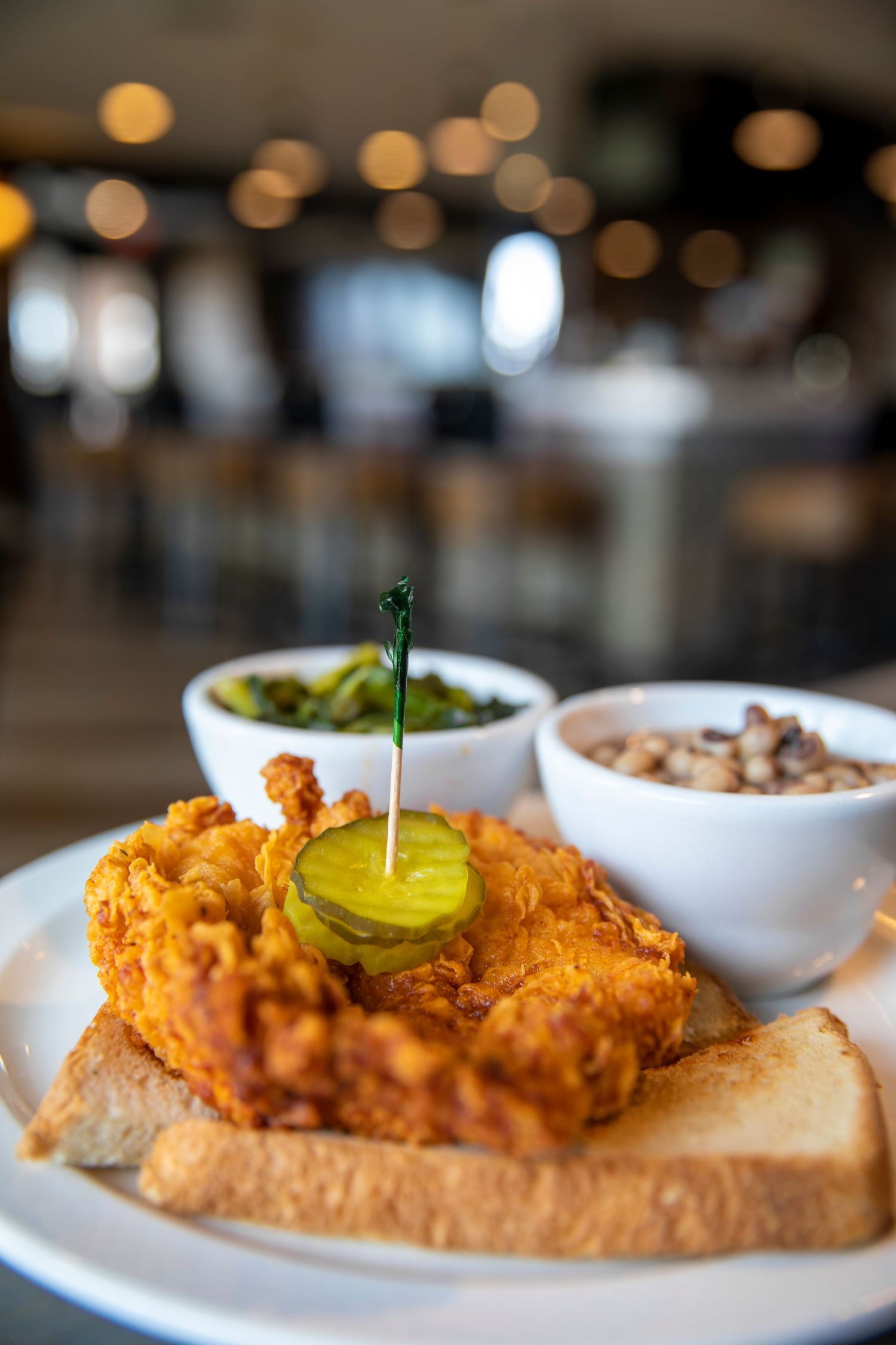 Nashville hot chicken with pickle on bread