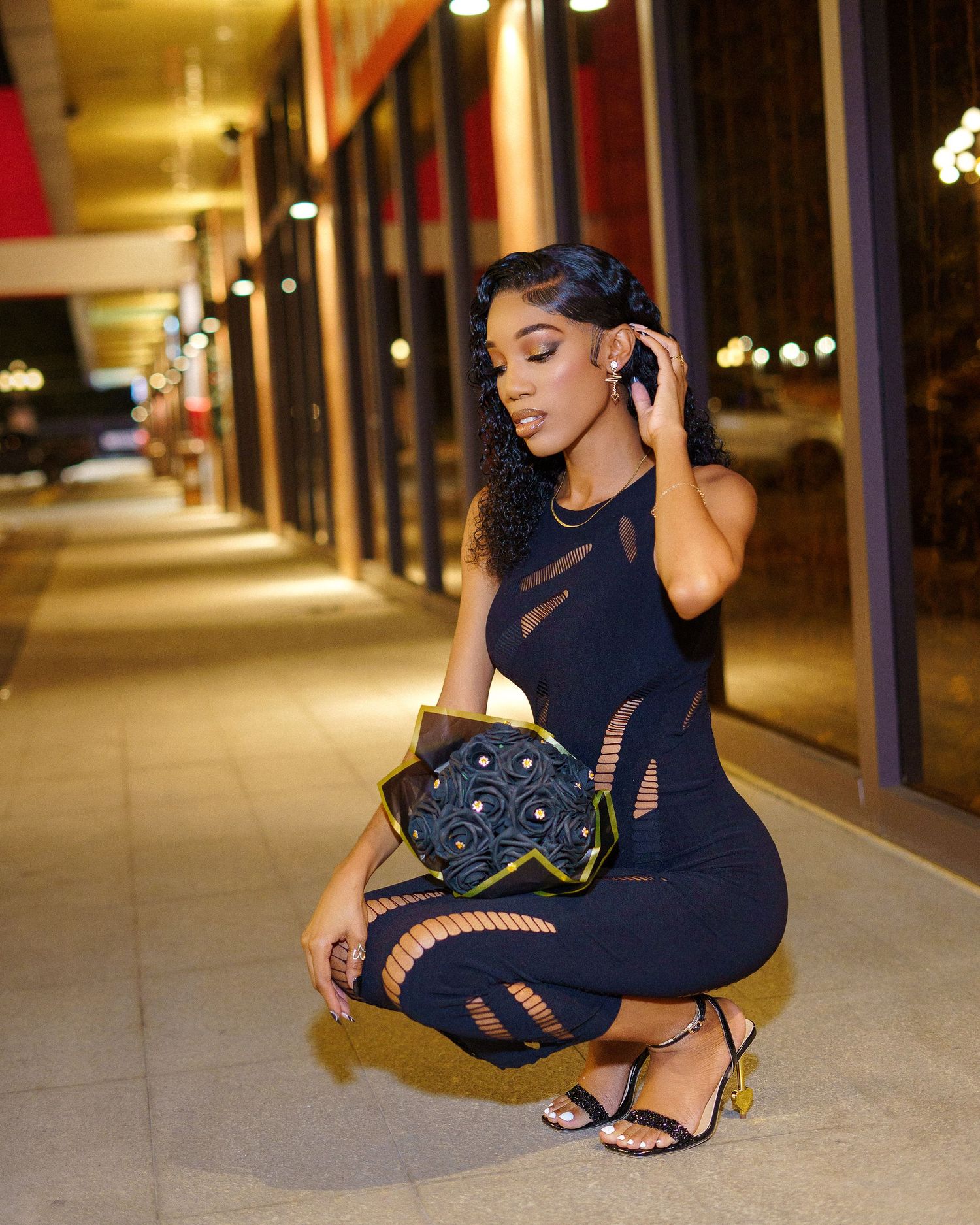 Fashion photography featuring elegant poses in navy dress at night.