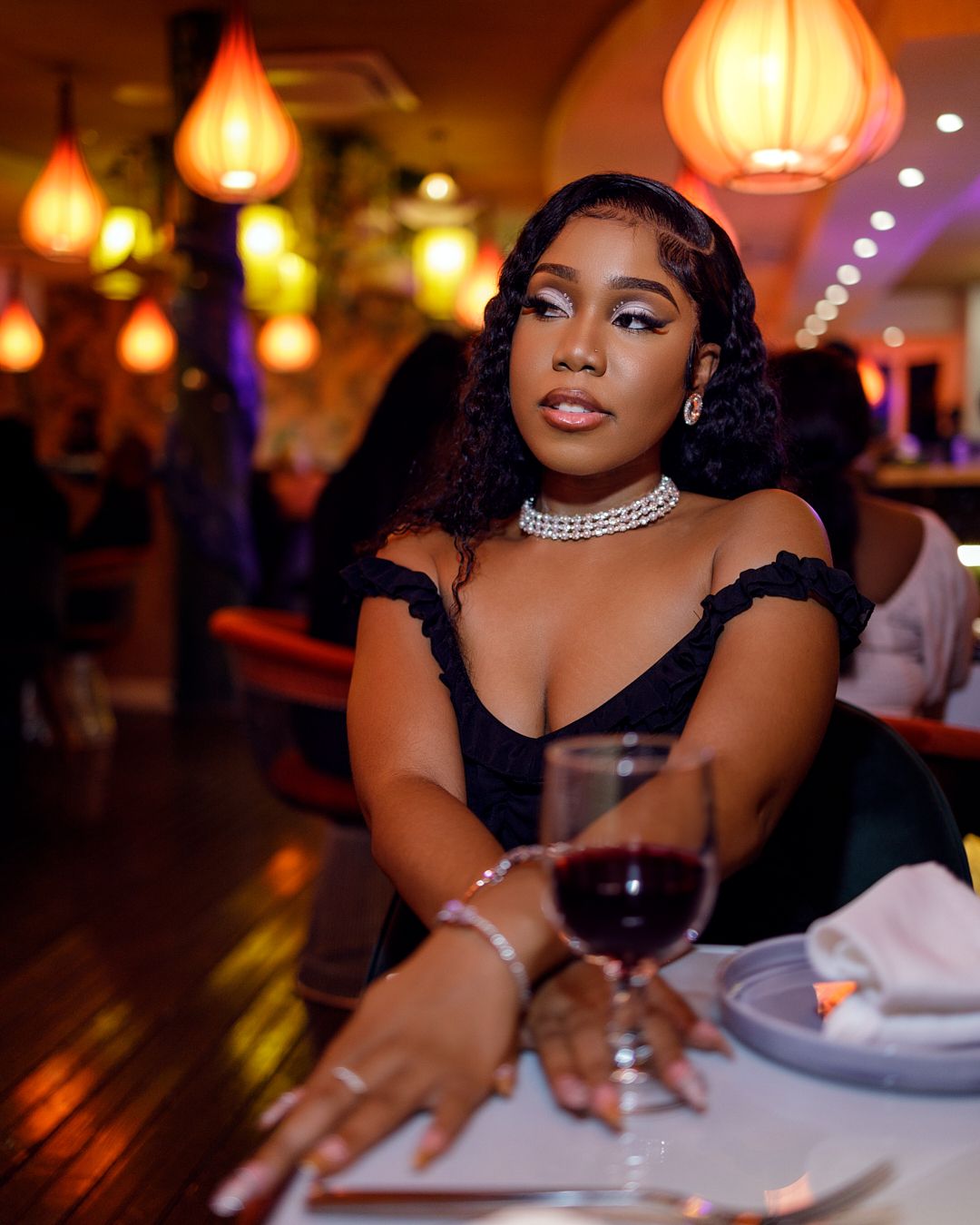 Candid dining moment captured in warm lighting with decorative lanterns overhead.