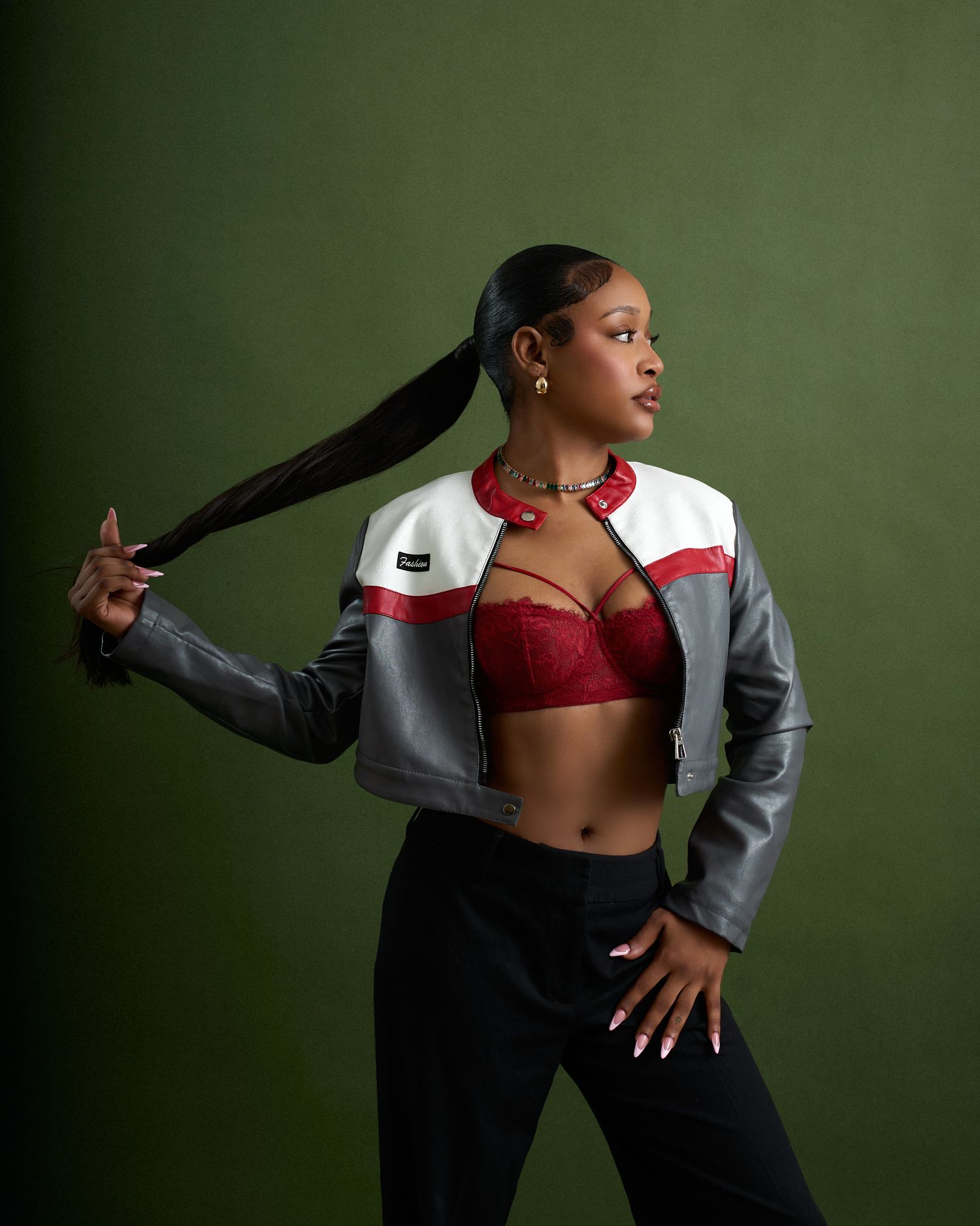 Dynamic poses showcase grey blazer and red lingerie combination against olive green studio backdrop.