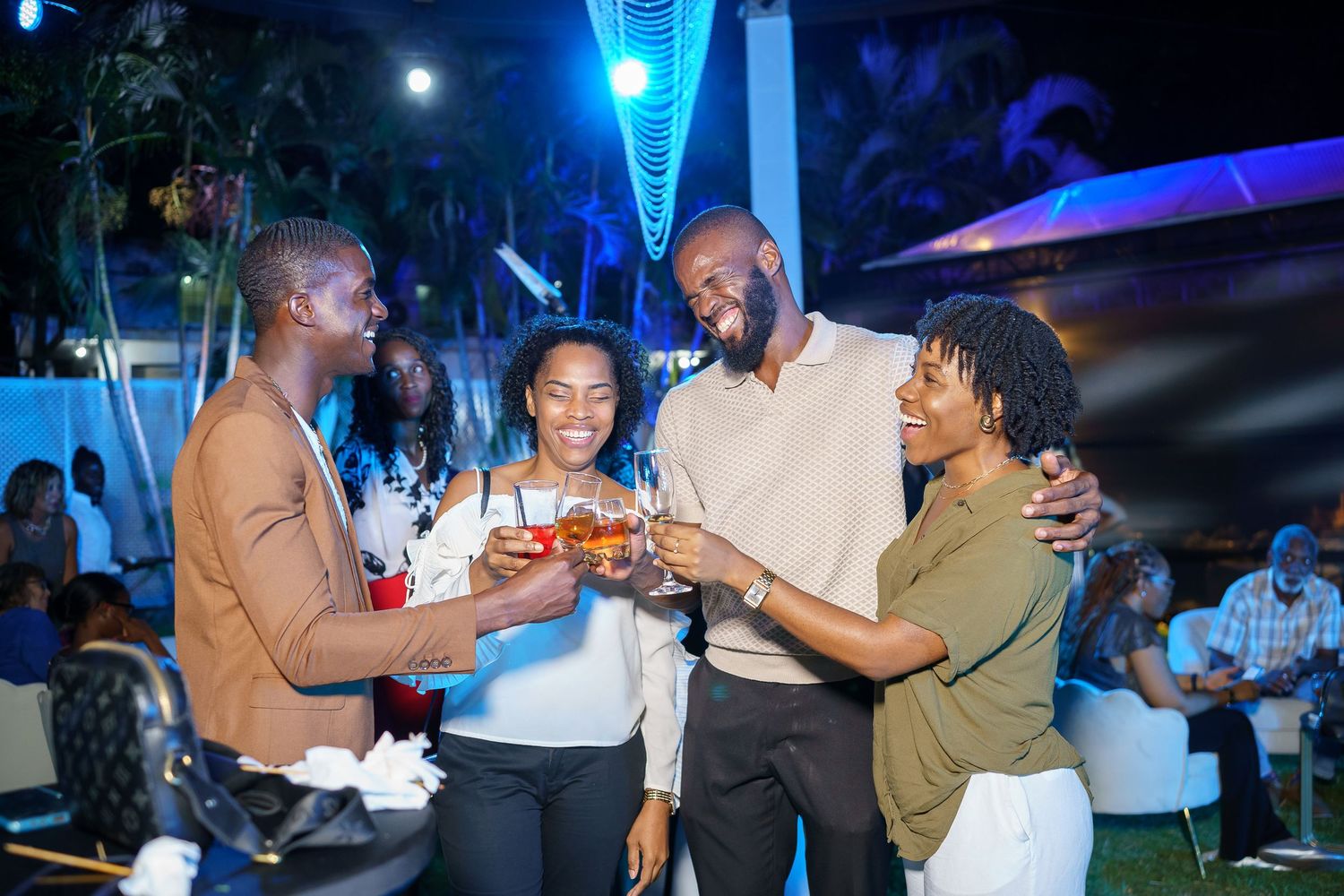 Friends toasting drinks and sharing food at VISA event