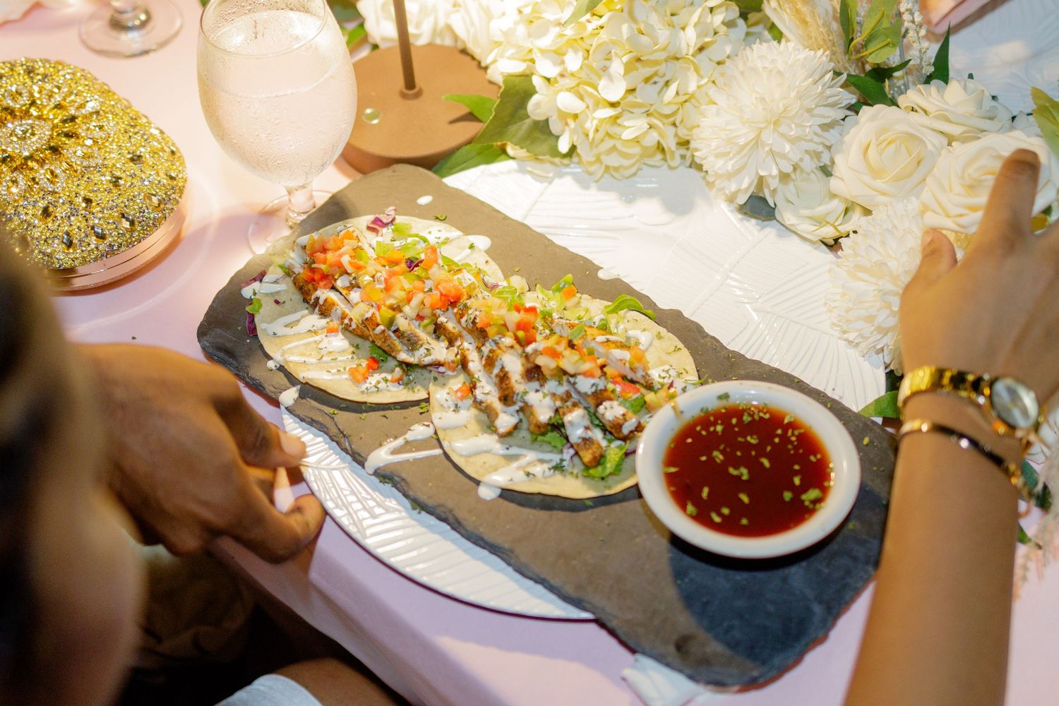 Close-up of appetizer plates being prepared with colorful garnishes and sauces.