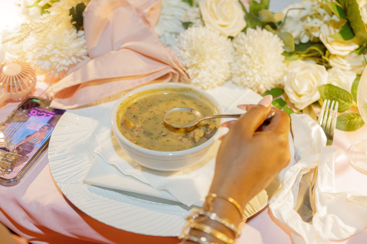An elegant table setting with white flowers and glassware at a restaurant.