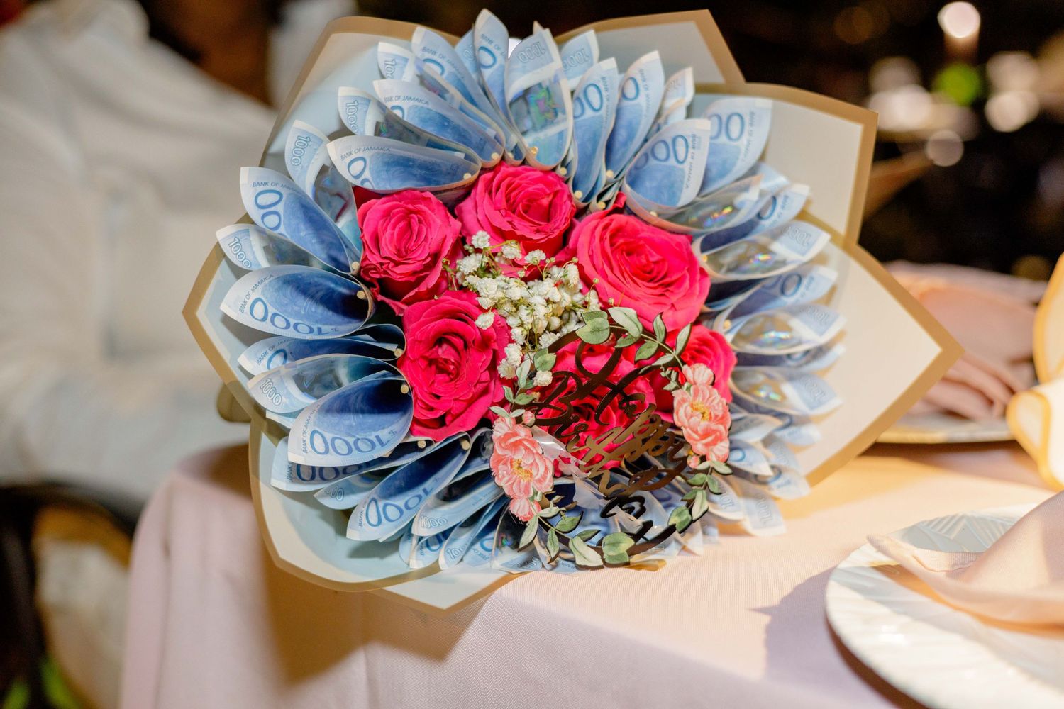 Decorative arrangement featuring blue and pink flowers with delicate accents.