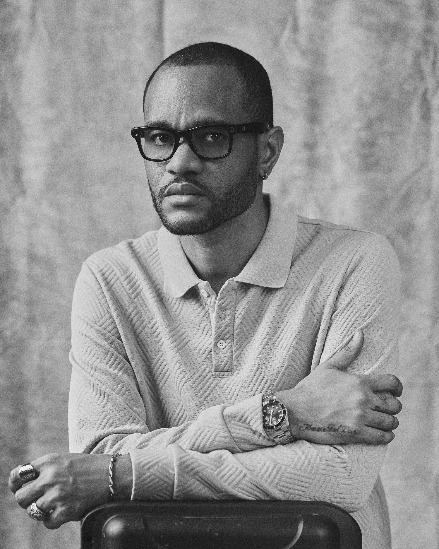 Black and white portraits showing contemplative poses in knit polo.