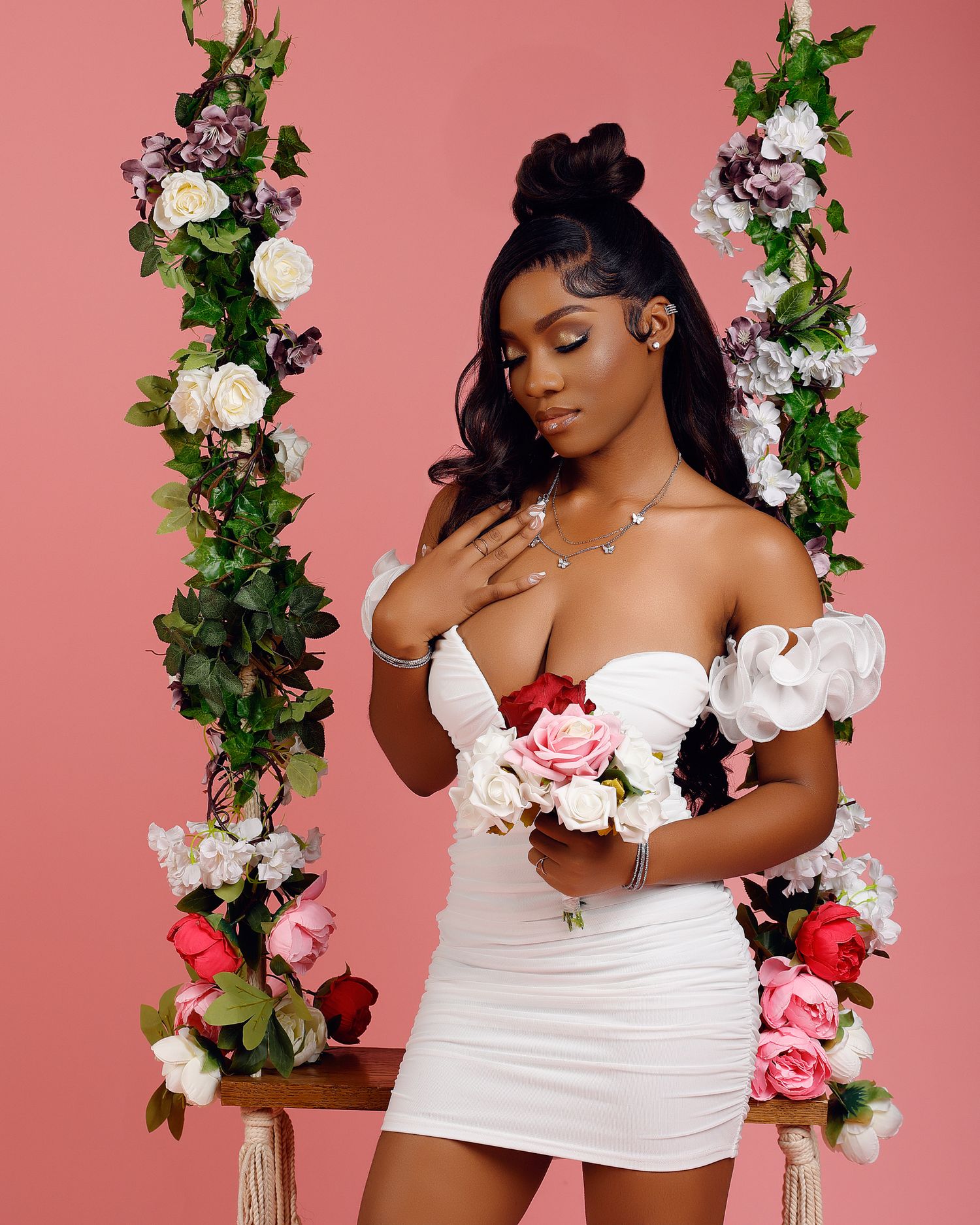Romantic boudoir photos with floral swing against pink background.