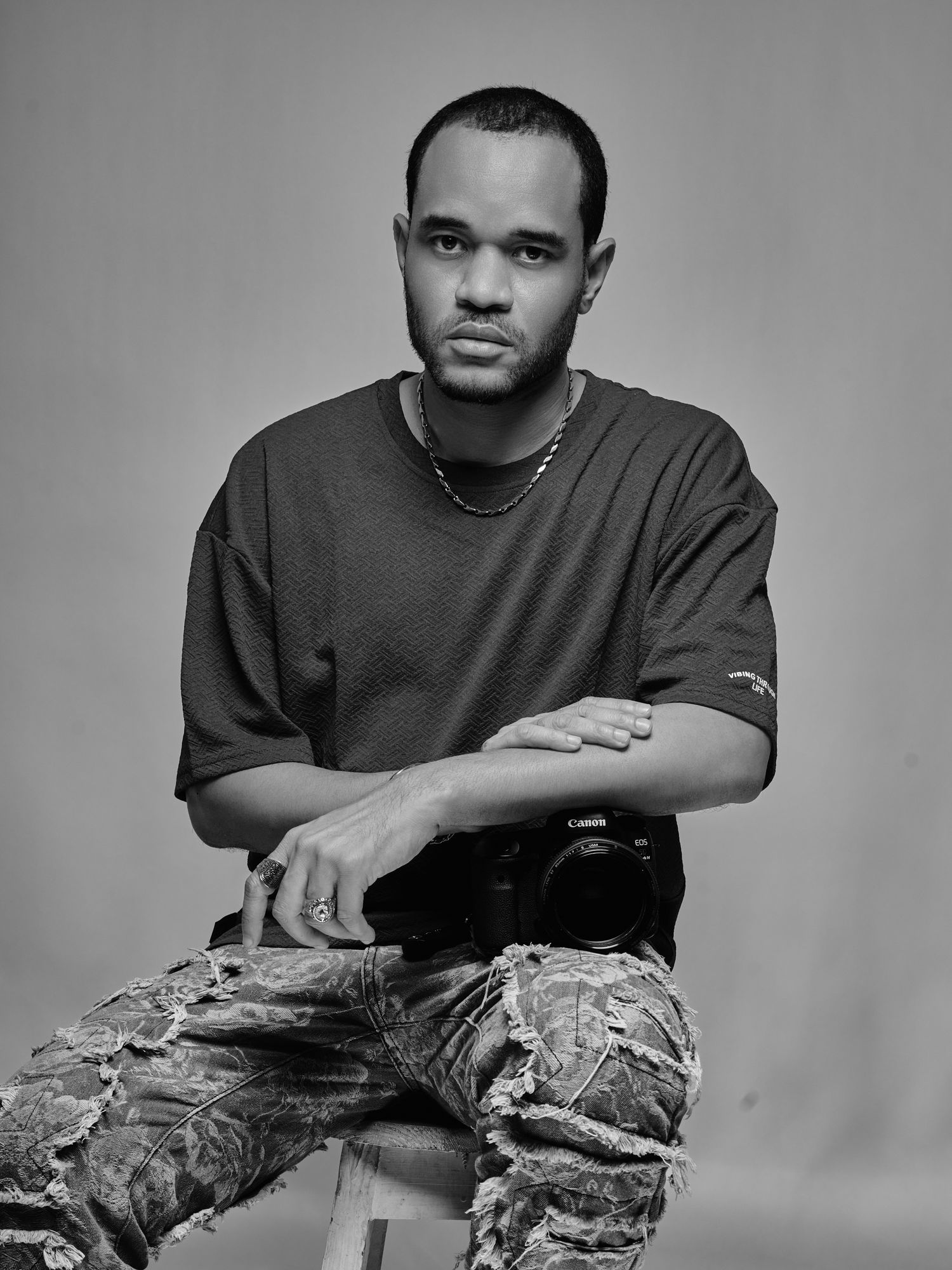 Studio portrait series showing photographer with camera in casual attire.