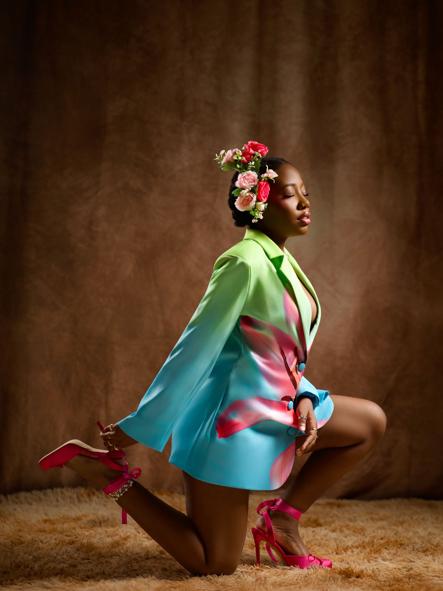 Artistic fashion shoot featuring model in lime green and turquoise outfit with floral accessories.