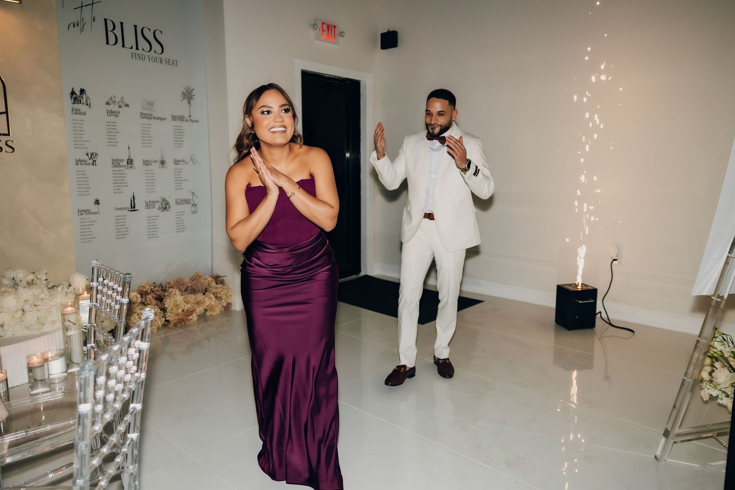 A celebration scene in an event space with purple decor and string lights.