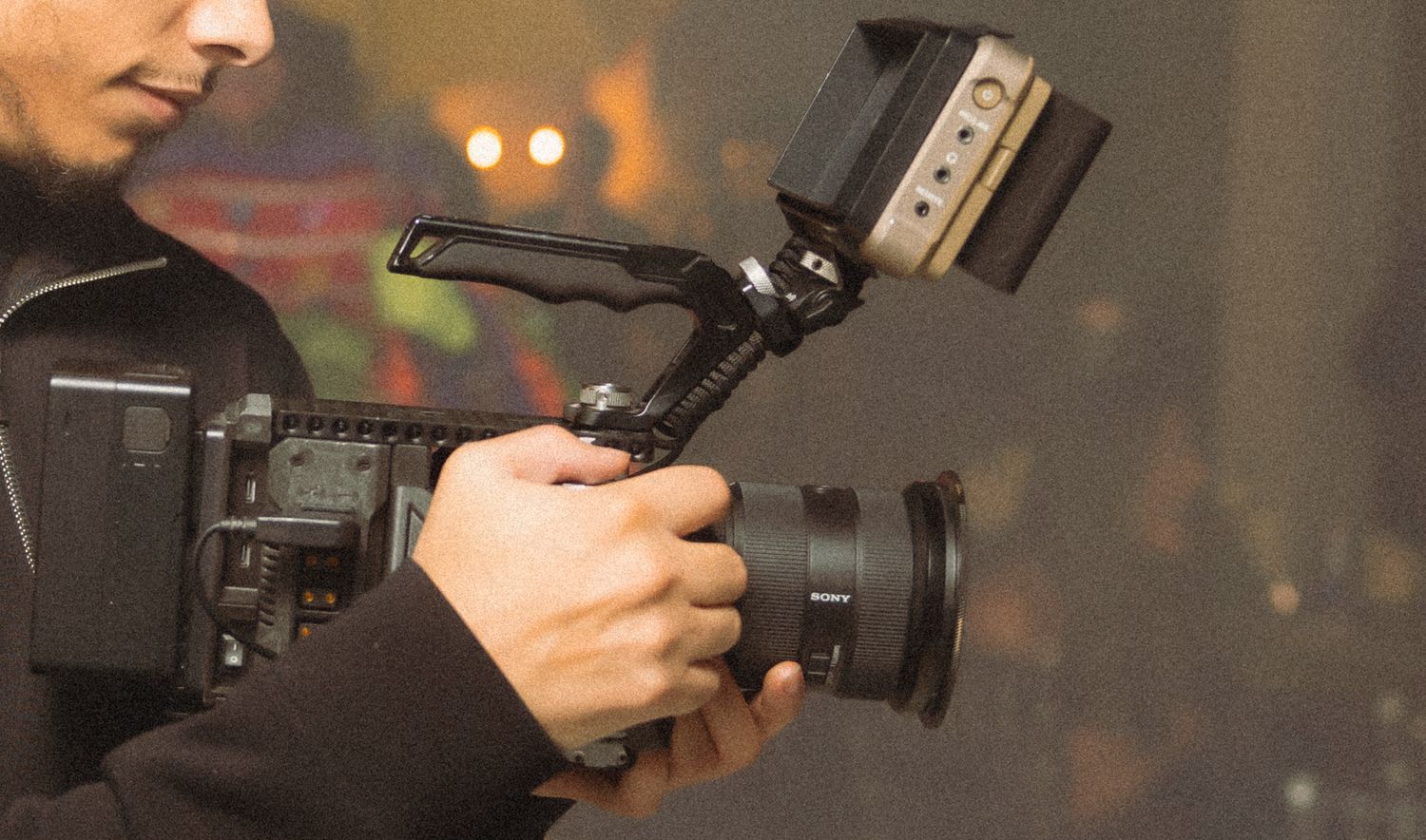 Professional photographer adjusts camera settings while shooting in a studio setting.