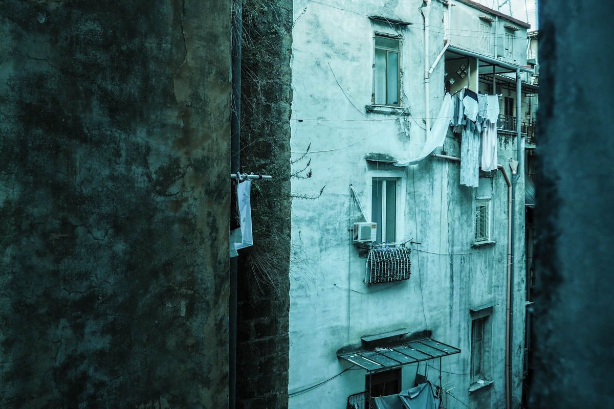 atmospheric glimpse of a traditional historic building in Forcella, Naples, Italy