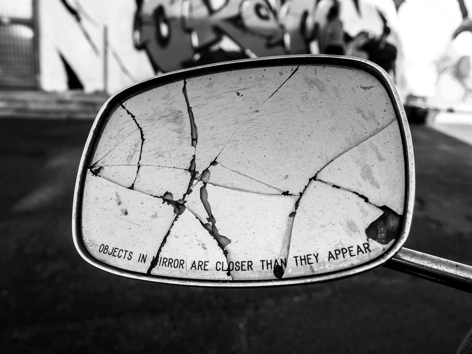 close-up of a shattered vehicle side mirror in Naples, Italy