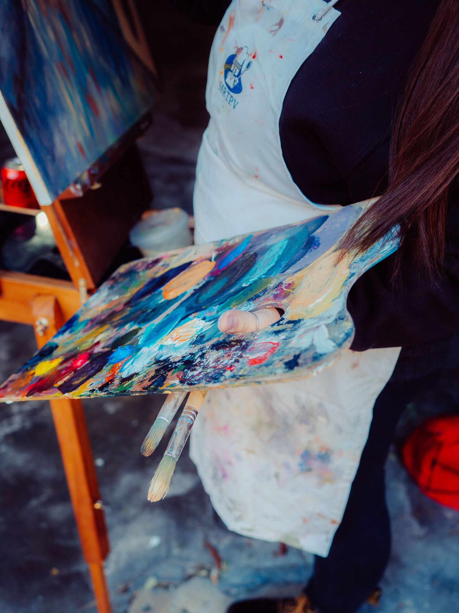 close-up of a female artist's vibrant oil paint palette