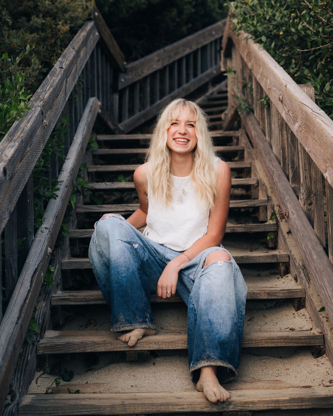 Beach portrait of young woman on the sand in Laguna Beach CA, shot by Makenzie Rae Photography