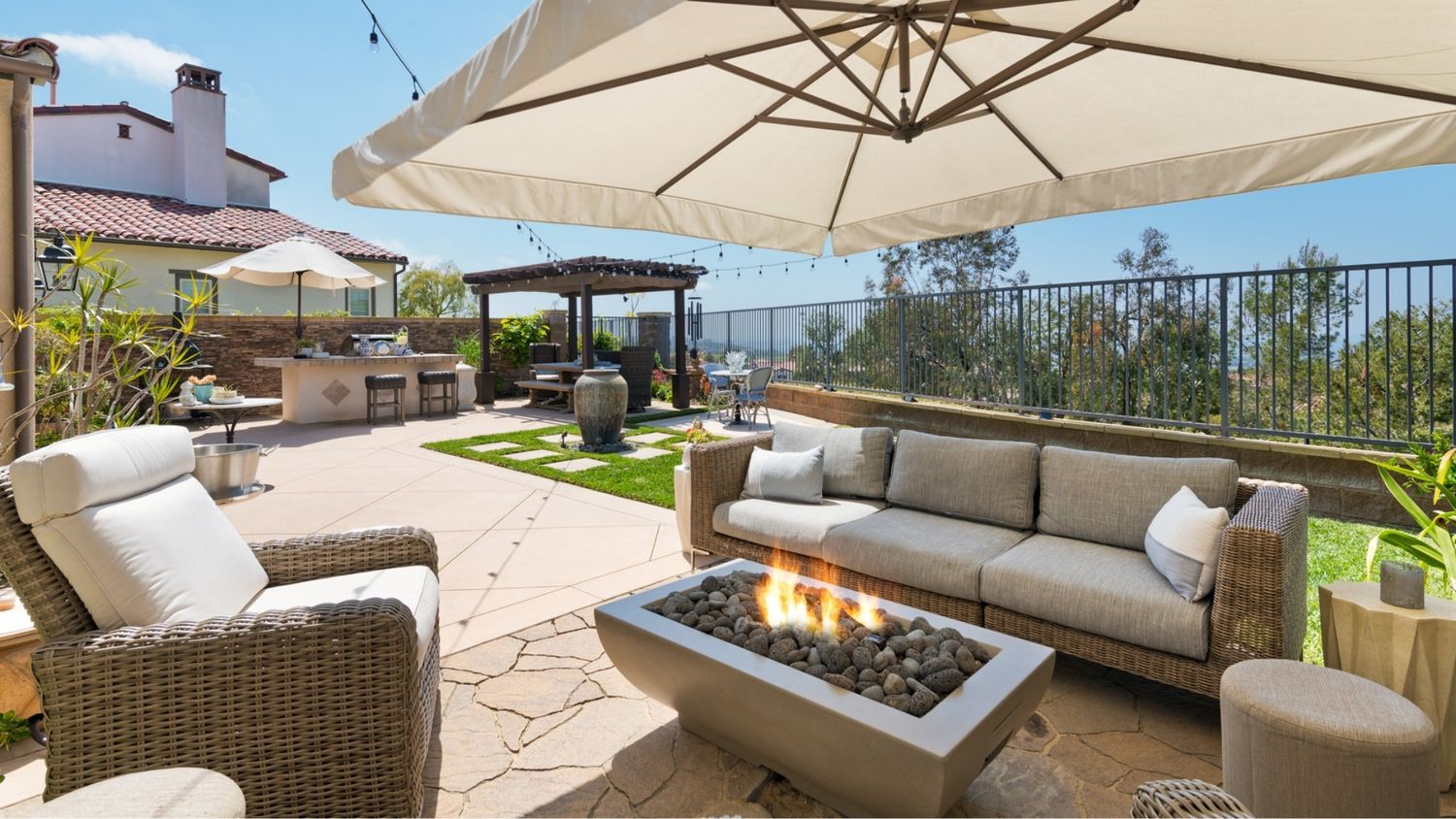 Backyard photo with fireplace and shaded pergola, shot by Orange County Real Estate Photographer Makenzie Rae Photography